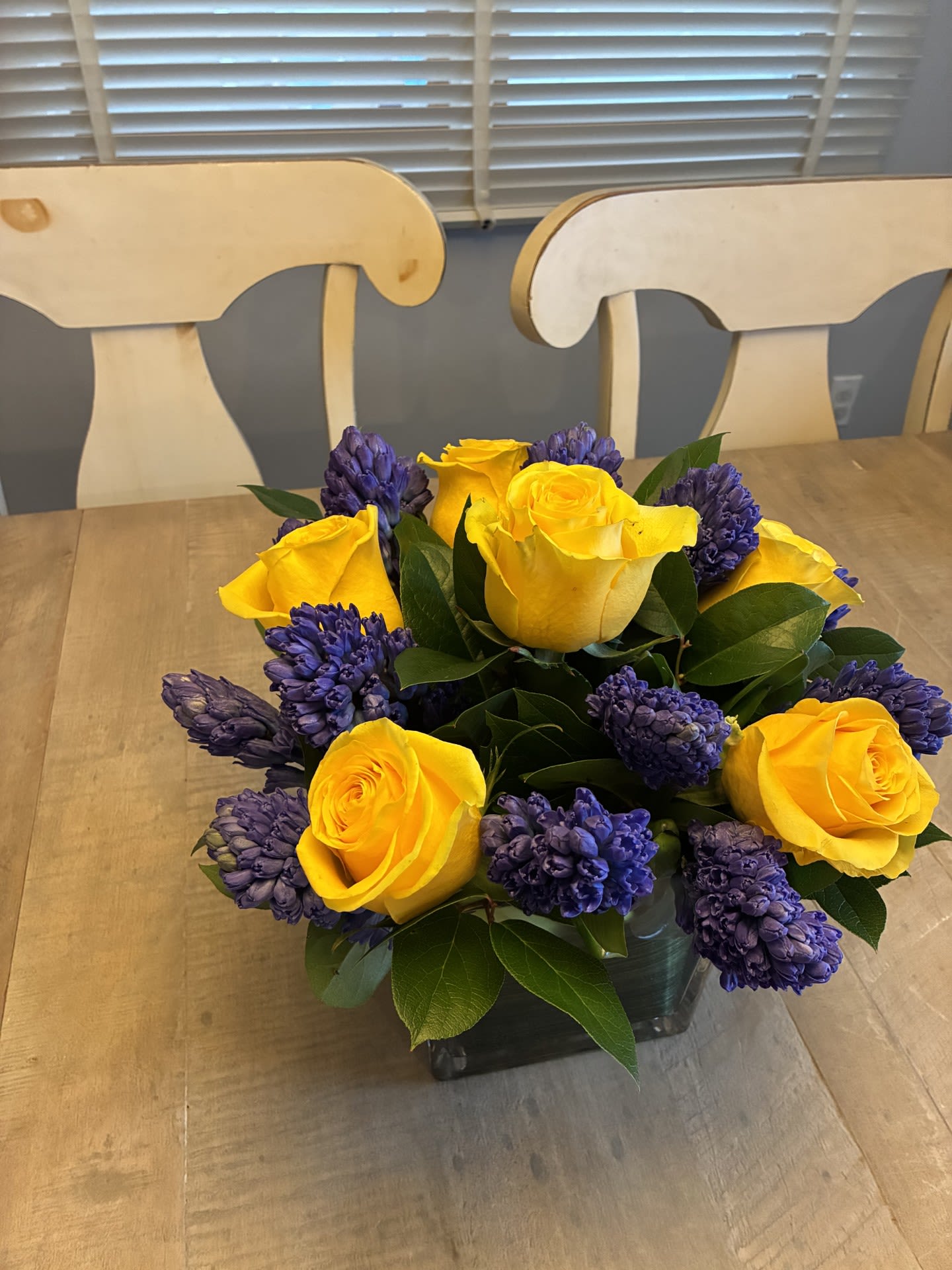 Jeanne- here comes the Sun - Here comes the sun - this Medium size arrangement smells as good as it looks with the Blue Hyacinth , made in a lined 5 1/2 inch Glass cube.  Standing about 13 inches tall and wide.