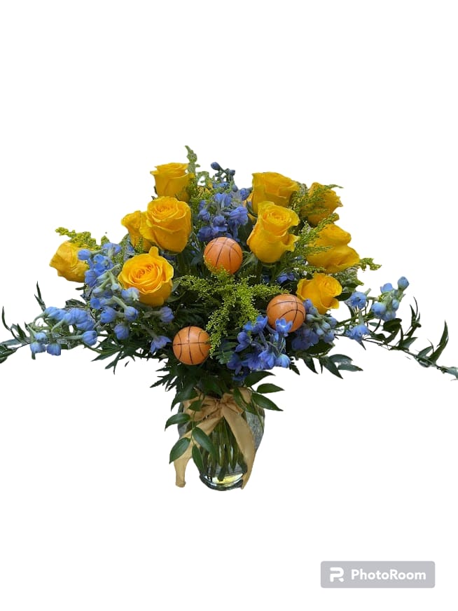 Yellow roses and blue flowers in a glass vase with small basketball picks