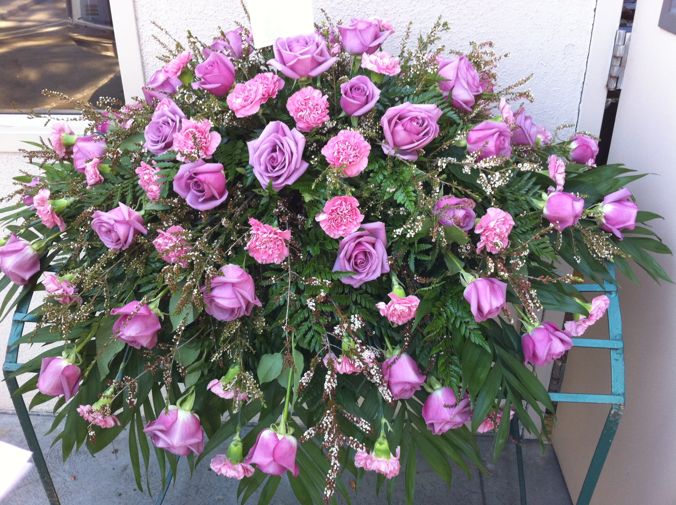 Large pink and lavender floral spray with roses and carnations