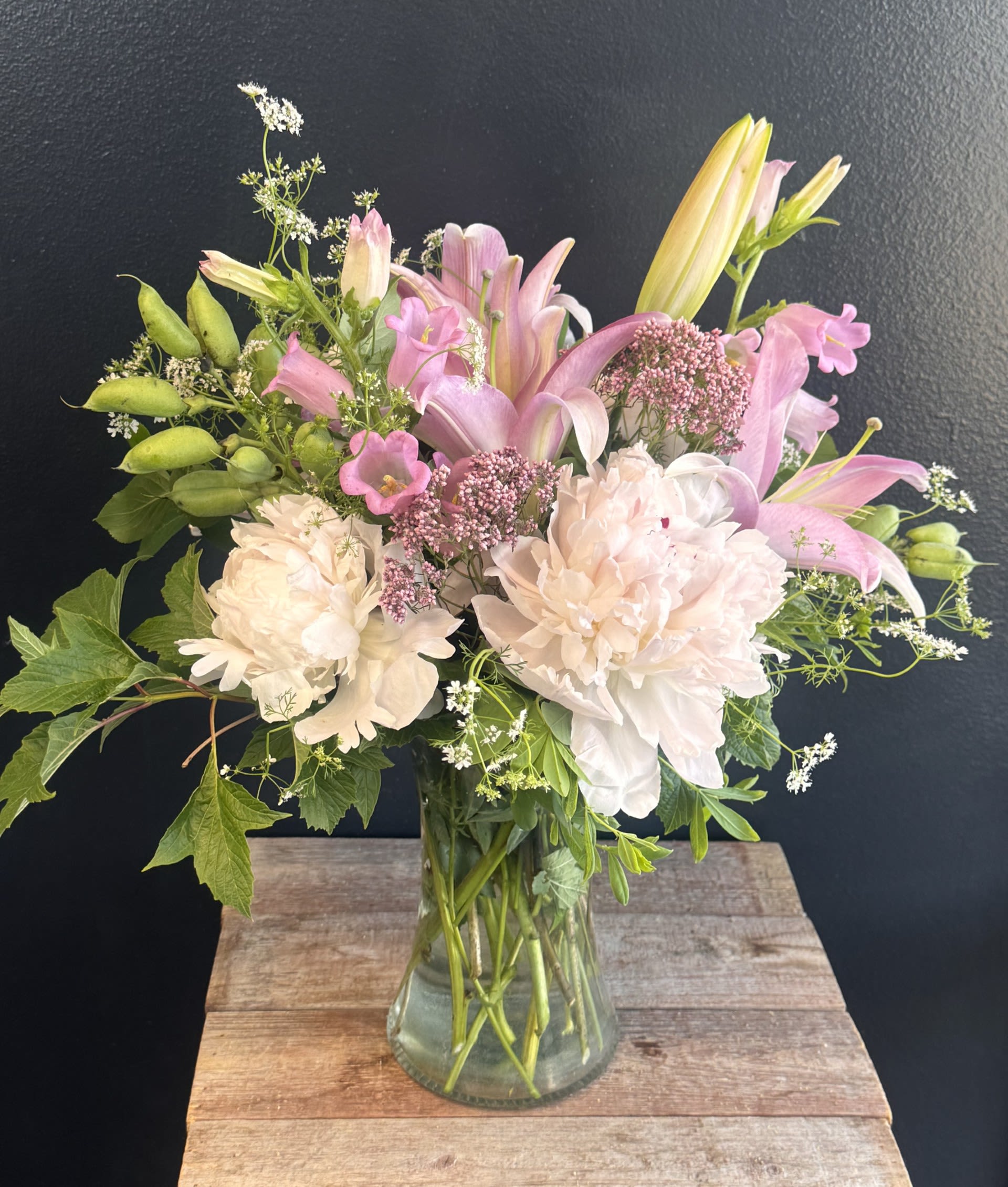 Peony and Lilies - A bouquet overflowing with peonies, and lilies creates a soft, romantic statement. Blousy peonies bring velvety fullness, lilies add sculptural elegance, and Lilies rise through the arrangement with graceful height. Together, they form a dreamy, garden‑style composition that feels both luxurious and effortlessly natural.