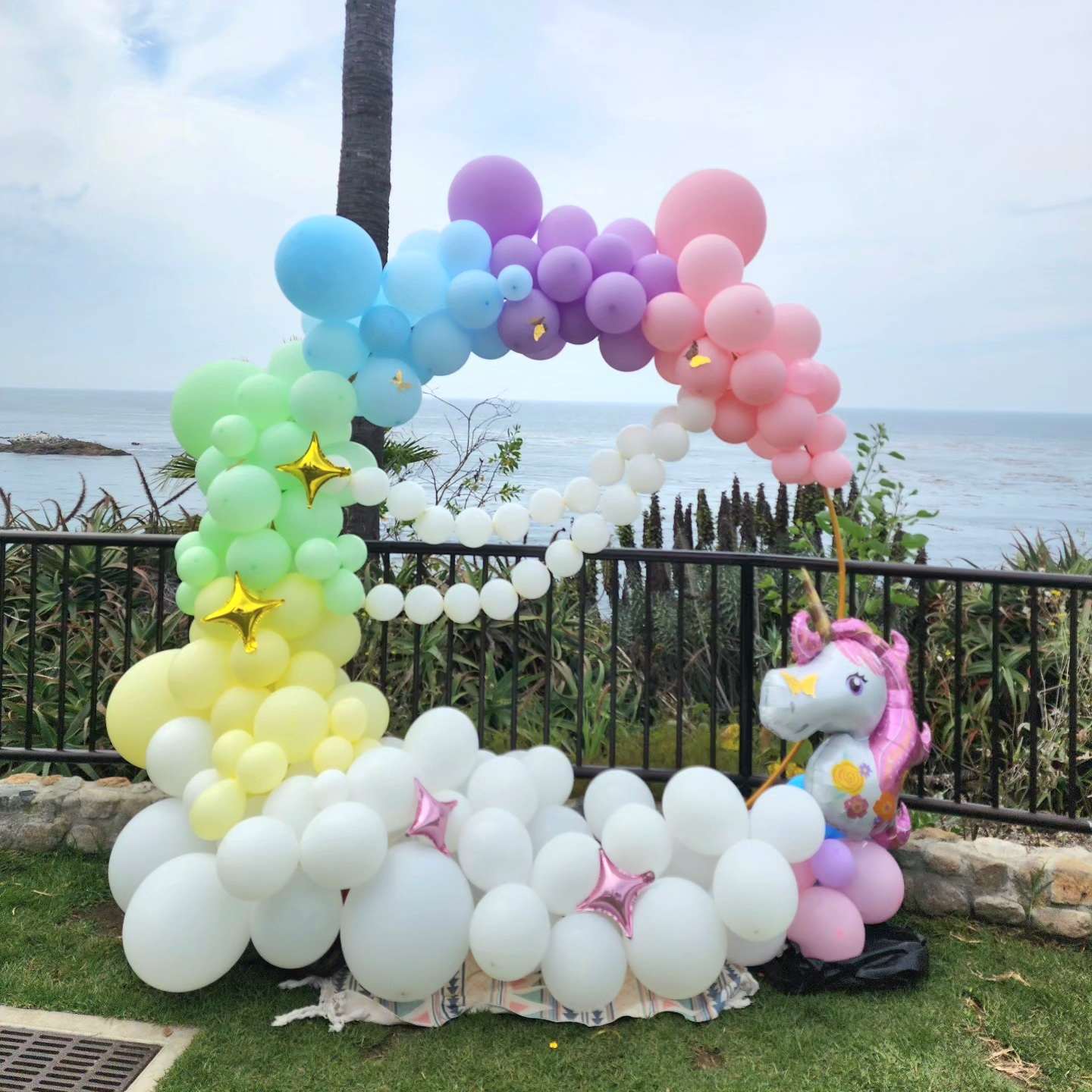 Unicorn Party Balloon Arch - Step into a world of magic with our Unicorn Party Balloon Arch. This enchanting arrangement features a vibrant mix of pastel and iridescent balloons, adorned with whimsical unicorn accents. Perfect for birthdays, themed parties, or any celebration that seeks a touch of fantasy, this arch creates a dreamy entrance or backdrop, transforming your event into a magical unicorn wonderland. Let this delightful balloon arch set the stage for a celebration filled with wonder and joy.