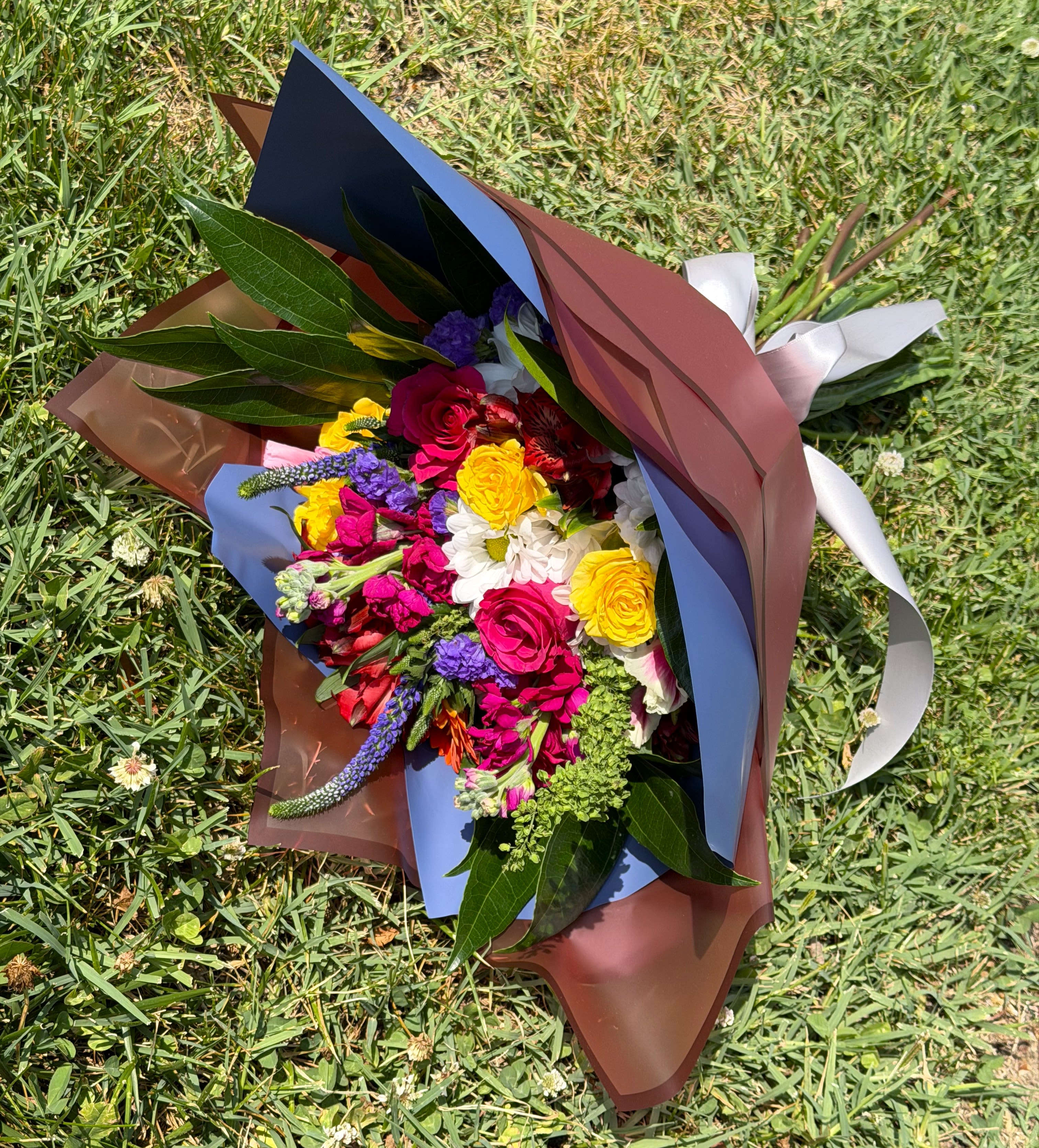 Eastern Graduation Bouquet - Here is a bouquet for our Eastern 2026 Graduates! The bouquet will be made of a variety of seasonal flowers and then wrapped in paper the colors of Eastern High School. Limited availability!! 