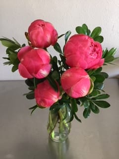 Pink peonies arranged in a clear glass vase