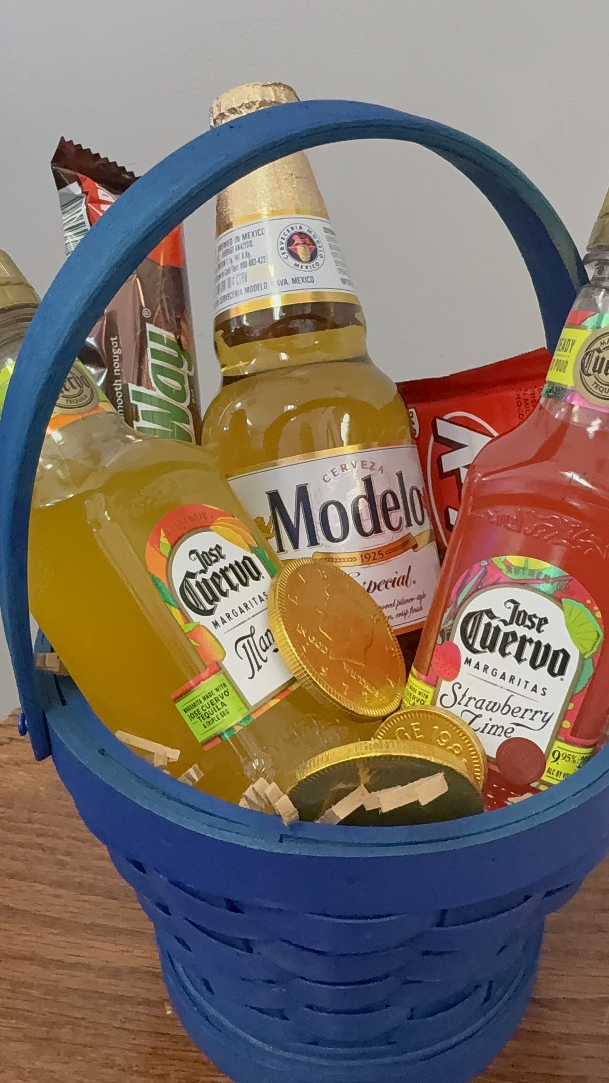 happy fathers day basket - Bright blue woven basket packed with miniature liquor bottles, candy bars, and chocolate coins makes this Father's Day basket a playful, indulgent gift that reads as a celebration in a box. As a Father's Day or birthday gift (and equally fitting for retirement, congratulations, or "just because" moments), it delivers a cheerful, casual vibe the person you're thinking of will recognize as fun and festive rather than formal-perfect for the dad who prefers a party-ready surprise over traditional flowers.  