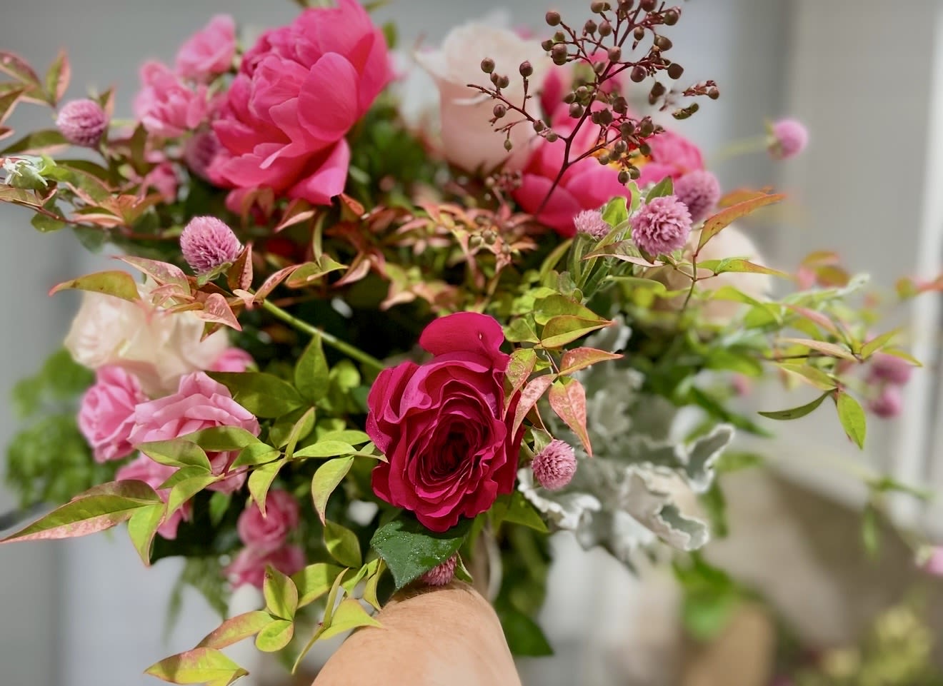 SUMMER HAND TIE BOUQUETS  - A gorgeous hand tie that is bright and beautiful with peonies and roses and tulips, berries and in season greenery… Wrapped up nicely and finished off with a silk ribbon bow.