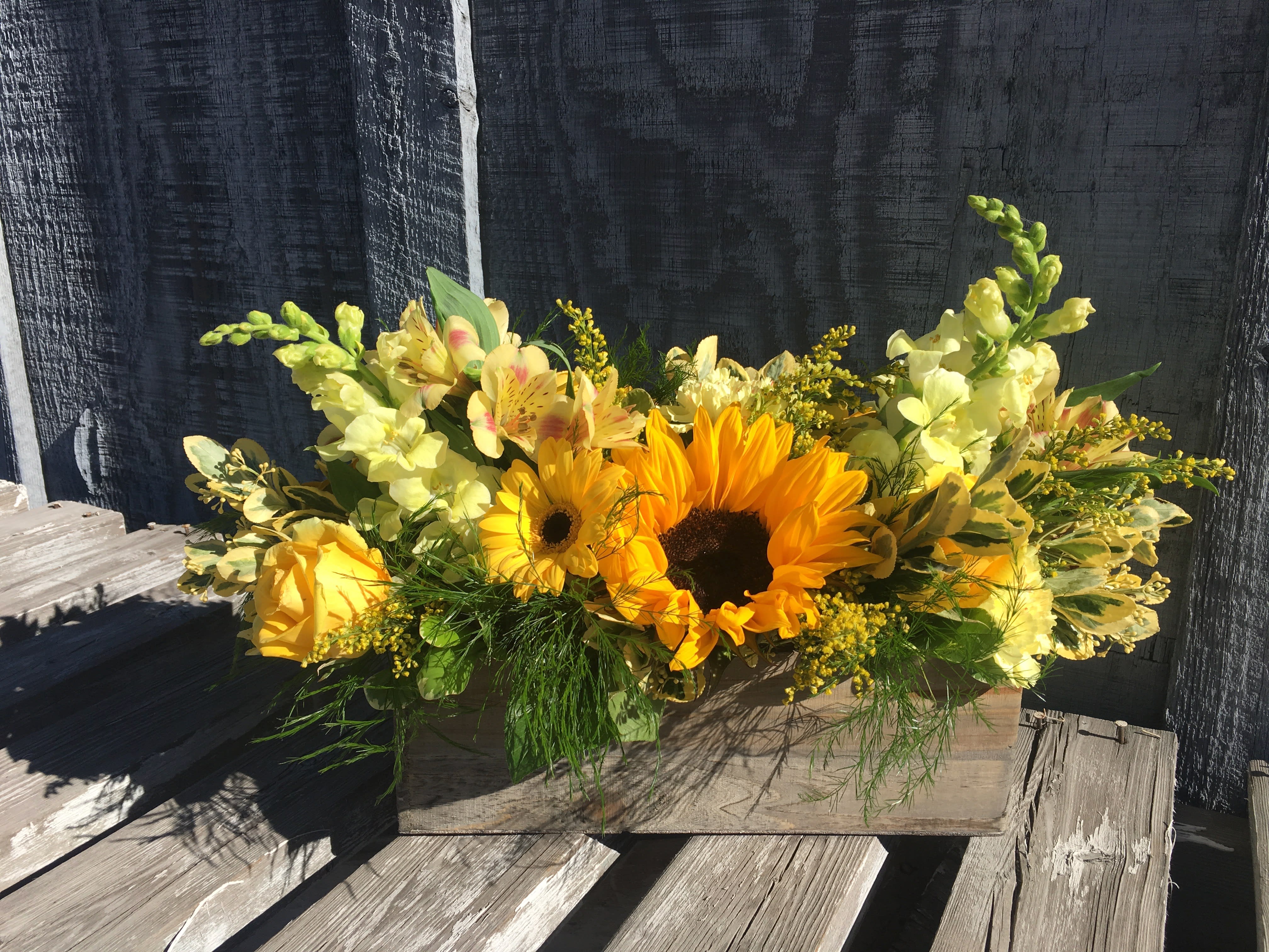 A Box of Sunshine - A bright and full beautiful array of yellow and orange flowers in a wooden box. 
