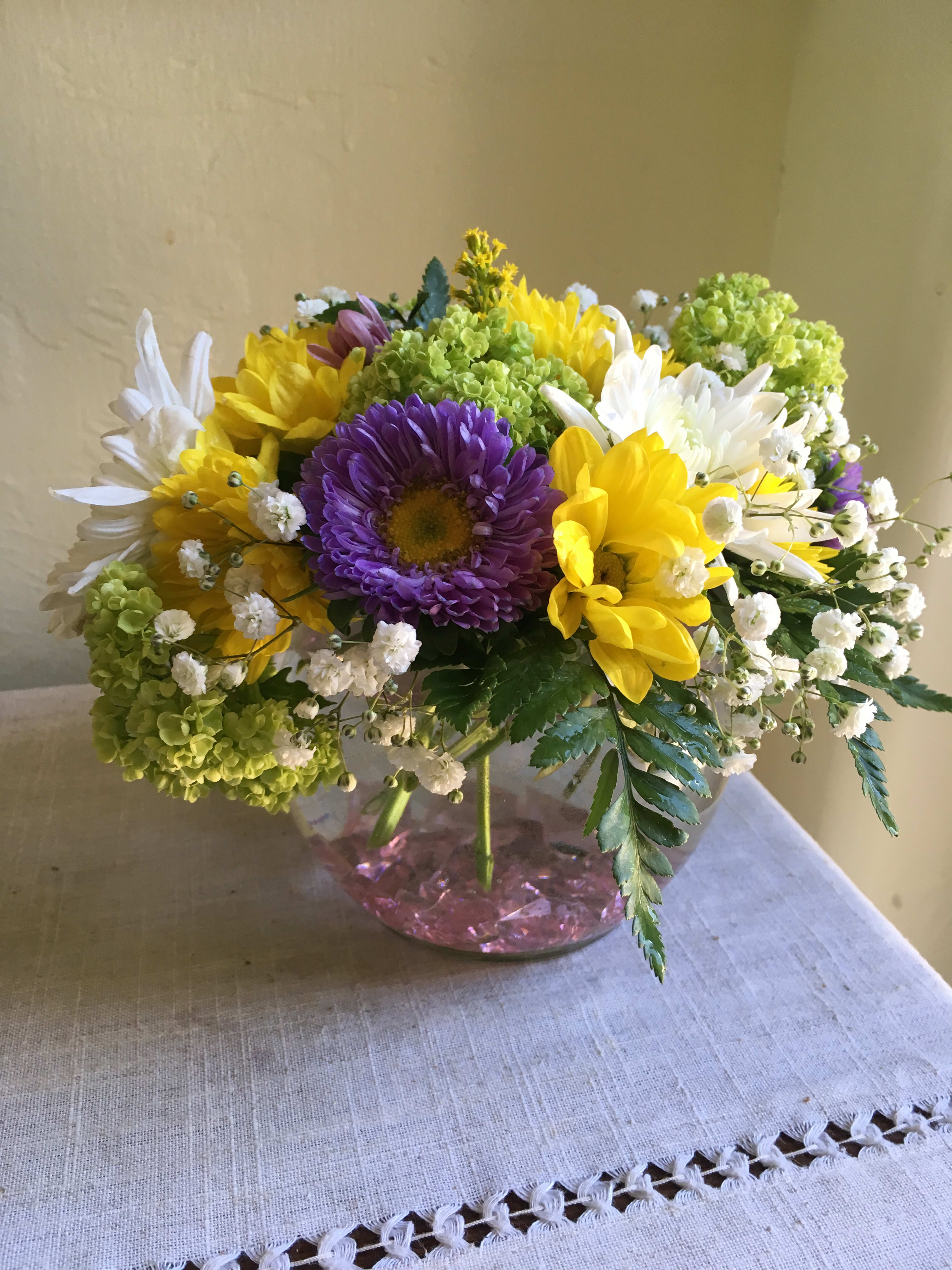 Springtime Surprise  - Fun, fresh and playful, this purple and yellow bouquet in a bubble vase will certainly delight your friend or loved one!  