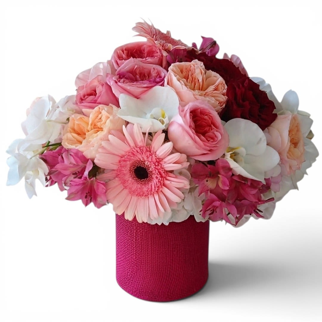 Pink Beauty Blossoms Designer's Choice - Designer's choice; made beautifully from my pink and vanilla blossoms of the day roses orchids hydrangeas and so much more arranged in a tall modern glass cylinder vase. Beautiful and perfect to send today to show them how much you care. All of my bouquets are always made unique and extra special each and every time. Send them your deepest condolences.