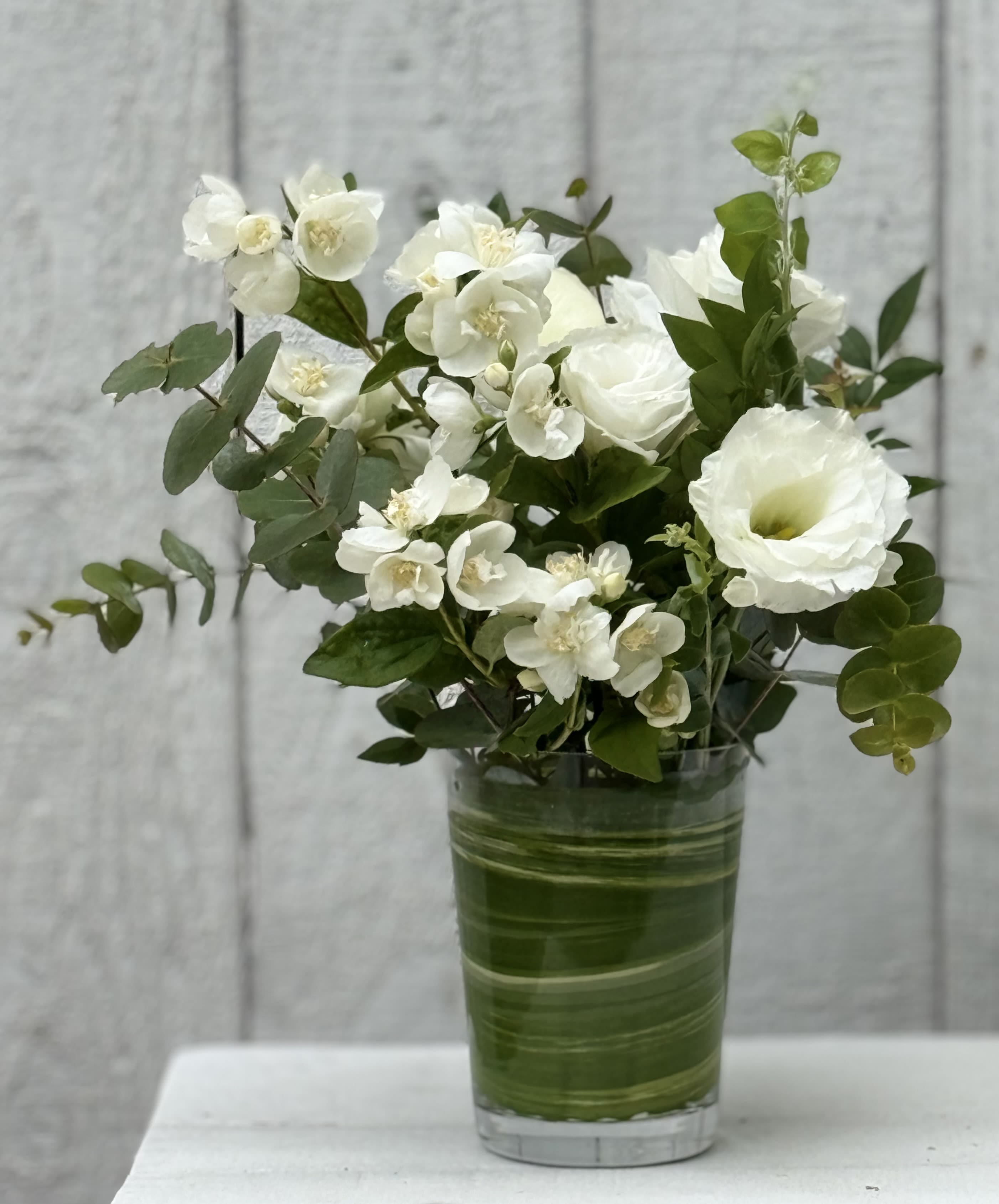 AROUND THE HOUSE (3 LOVELY WHITE ARRANGEMENTS) - Adding flowers to your home can bring so much joy and comfort. I’ve designed these pretty white and green arrangements to place in 3 different areas of your home. Or, place all three in one spot and really enjoy just looking at them. They have beautiful summer white blooming branches, lisianthous,roses,ranunculous, and soft pretty greens.  Dimensions, larger 2 @ 6x4 , middle one, smaller 4x4)…. Pretty glass containers……..