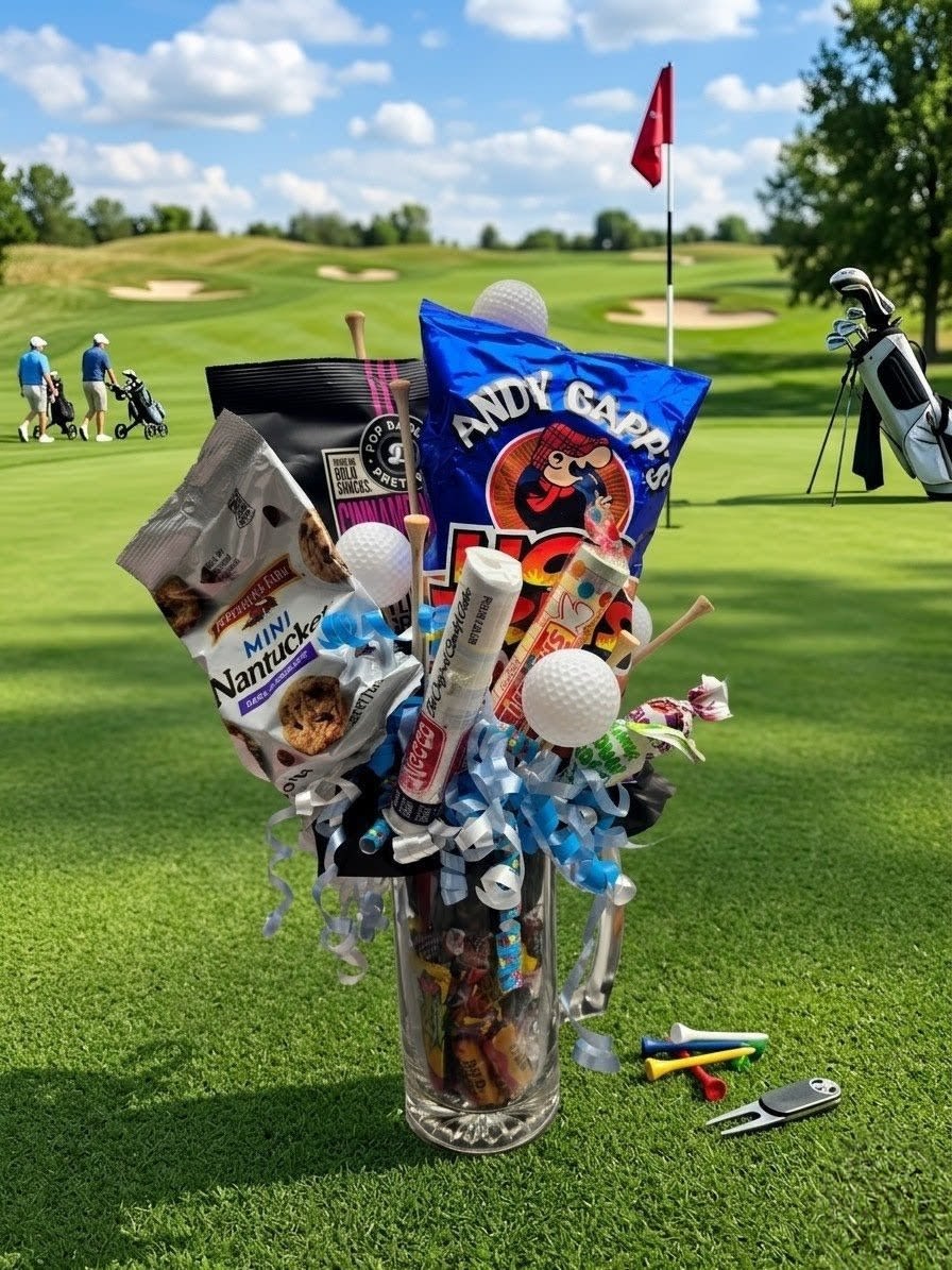 The Hole in One! - A "Hole-in-One" Gift for Father’s Day! ️  Looking for a gift that’s right up Dad’s fairway? Skip the boring tie this year and surprise him with a custom creation that hits the sweet spot!  Our "Par-Fect Dad" Gift Mug is fully loaded with his favorite snacks and golf-themed fun.  What’s Loaded in the Bag: A heavy-duty glass beer mug, real golf tees and ball accents, Andy Capp's Hot Fries, Pepperidge Farm cookies, Pop Daddy pretzels, retro candies, and bite-sized treats. Expertly wrapped in festive ribbon for a perfect finish!  Why It’s a Guaranteed Winner:  "Whether he’s a weekend warrior on the course or just the undisputed champion of the snack aisle, this unique, handcrafted arrangement is the perfect way to show him some love."  Note: Specific snack brands or colors may vary slightly based on availability, but the presentation will always be a total classic