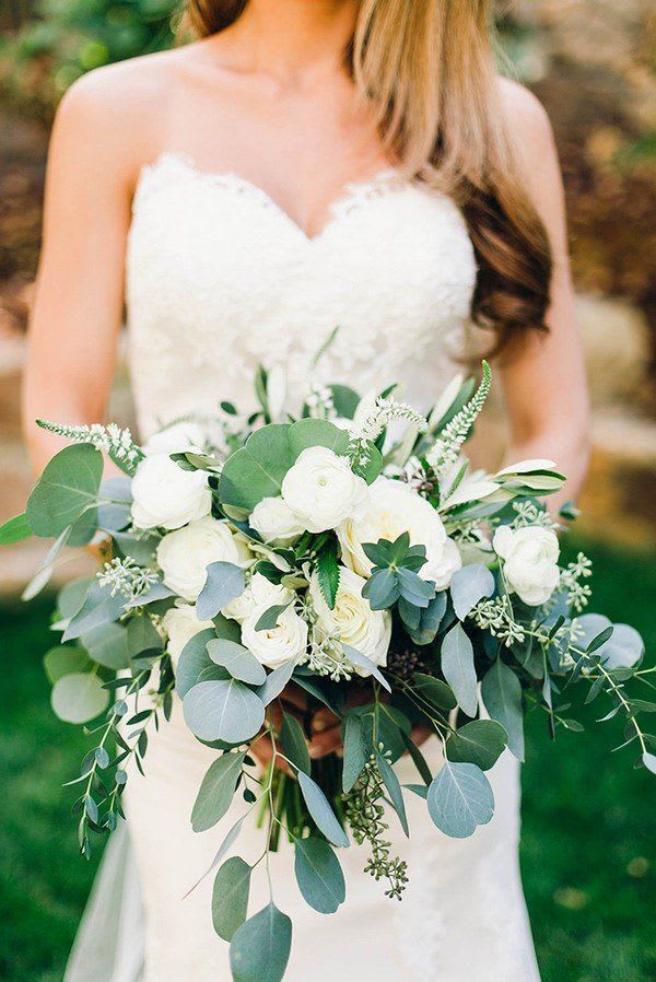 Bride holding a white bouquet with eucalyptus greenery