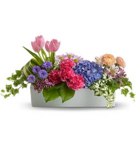 Mixed bouquet in a rectangular box with pink tulips and blue hydrangeas