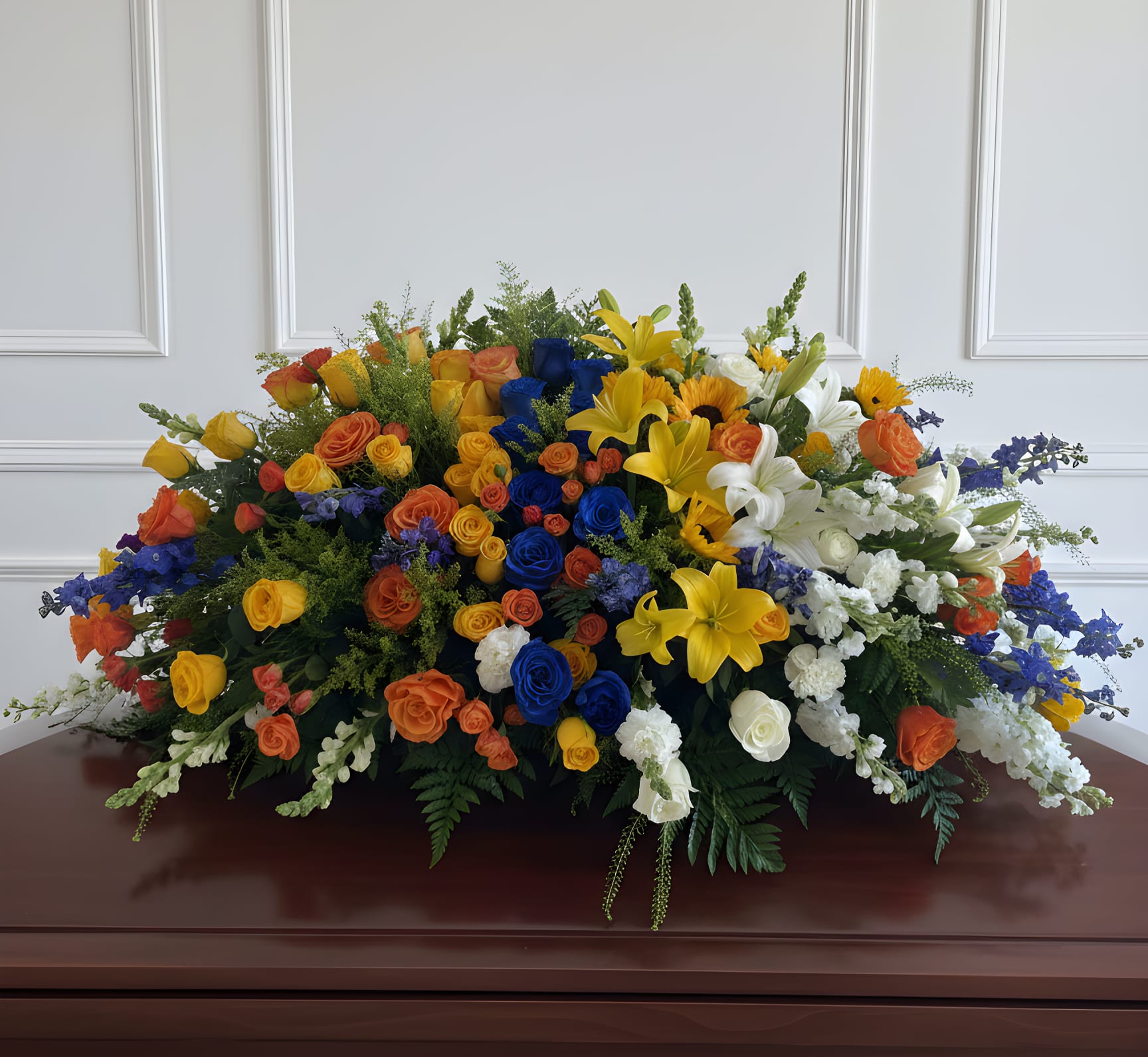 Large casket spray with multicolored roses and lilies