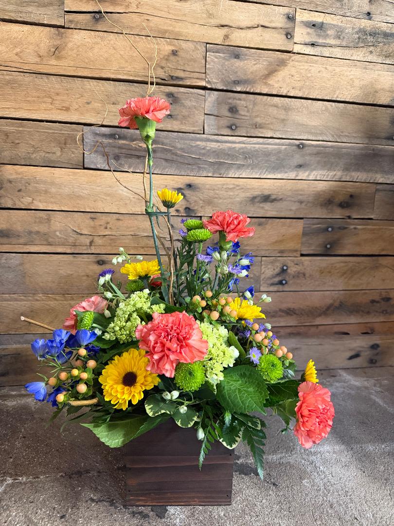 Rustic Blossoms -  BEAUTIFUL DESIGN, FILLED WITH DELPHINIUM, GREEN HYDRANGEAS, ORANGE CARNATIONS,FILLER, BUTTONS AND DAISIES. COLORS  AND FLOWERS MAY VARY FOR WHAT'S AVAILABLE AND FRESHEST.