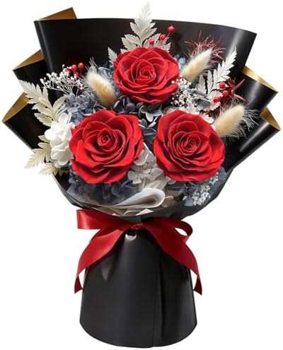 Preserved Flowers- Red and White Bouquet - Red roses take center stage in this preserved flower bouquet, their velvety petals framed by pale dried plumes, silvery foliage, and delicate white filler blooms for a striking, romantic contrast. Wrapped in glossy black paper and finished with a red satin ribbon, this compact arrangement reads dramatic and polished-perfect as an anniversary bouquet or a love-and-romance gift that feels intentionally elegant.  Please note that these flowers are preserved flowers.