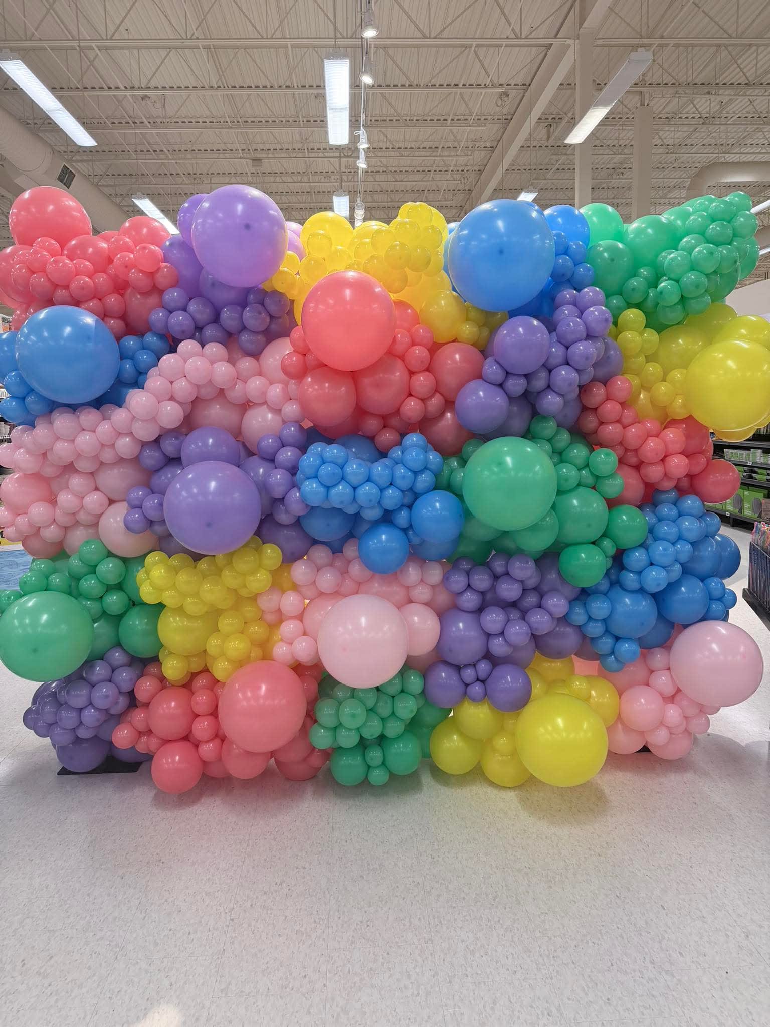 Balloon Wall - Our balloon wall installations feature extra lush, fully packed organic design using custom pastel (Standard) colors and monochromatic (Deluxe) balloons.  Note: personalized photo boards are available with 20 days notice; client may choose vinyl or chloroblast printing.