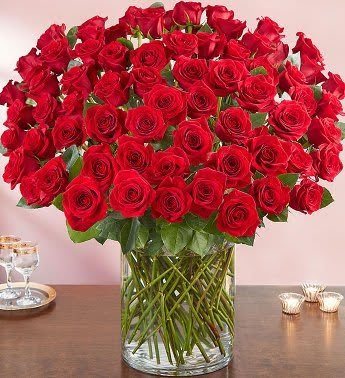 Large bouquet of red roses in a clear glass vase
