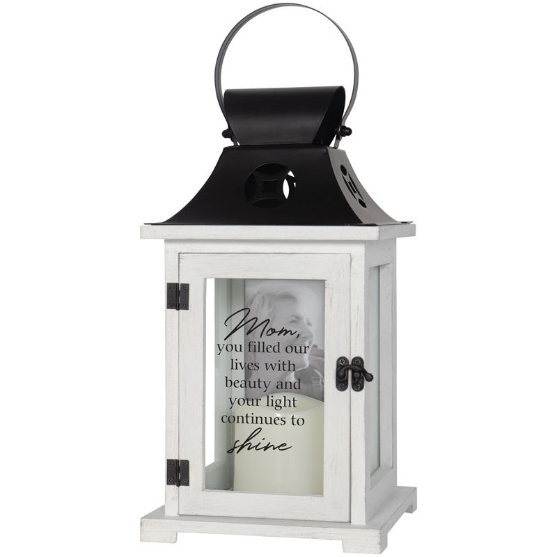 Mom's Light LED picture frame candle Lantern - Flameless LED Candle Lanterns are made from quality wood with metal top. Built in 4×6 picture frame. Built in automatic timer, 6 hrs ON/18 hrs OFF. Indoor use only. Lantern reads: "Mom, you filled our lives with beauty and your light continues to shine"