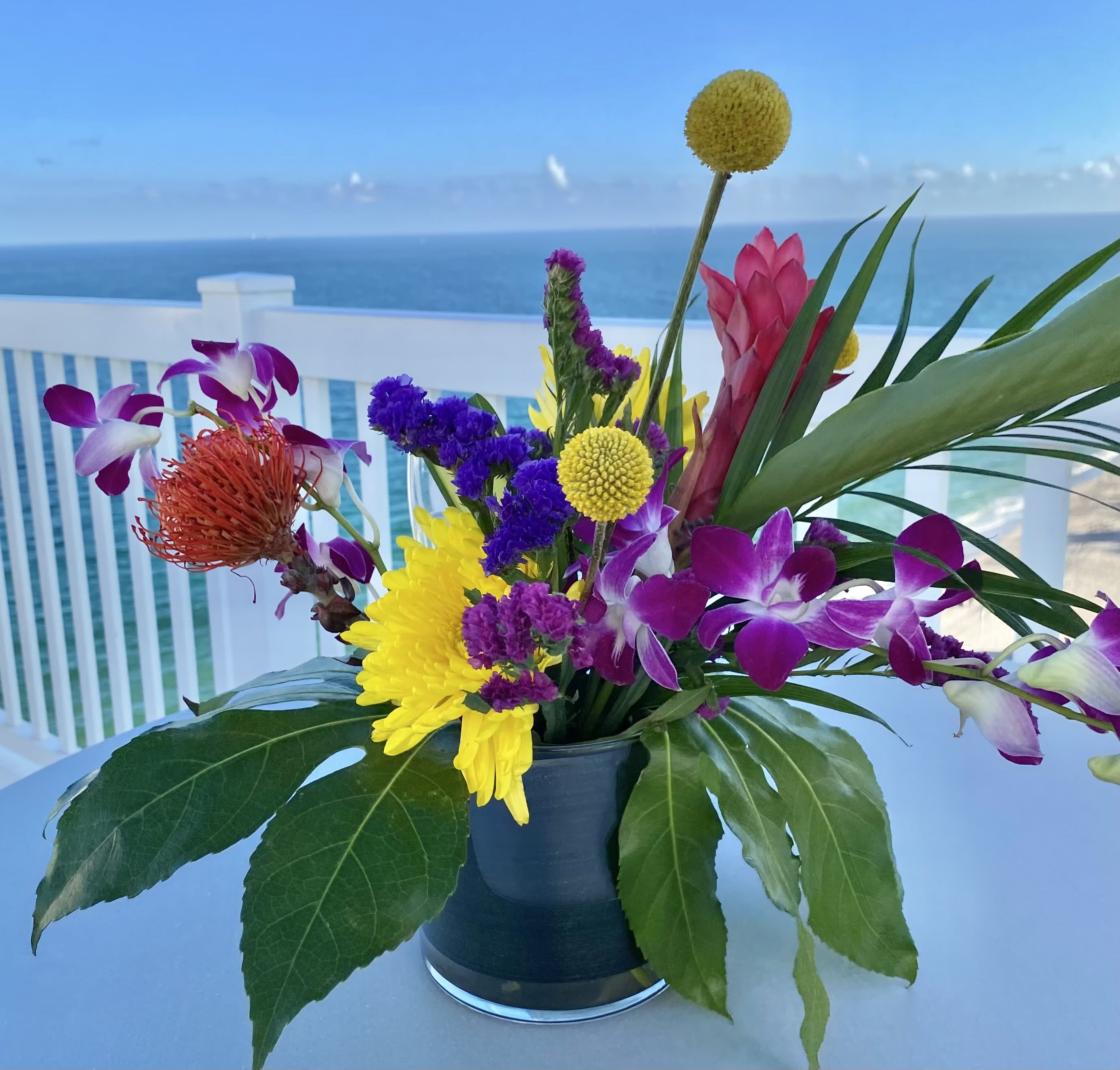Ocean view  - Tropical flowers, green in 6”x6” glass cylinder vase 