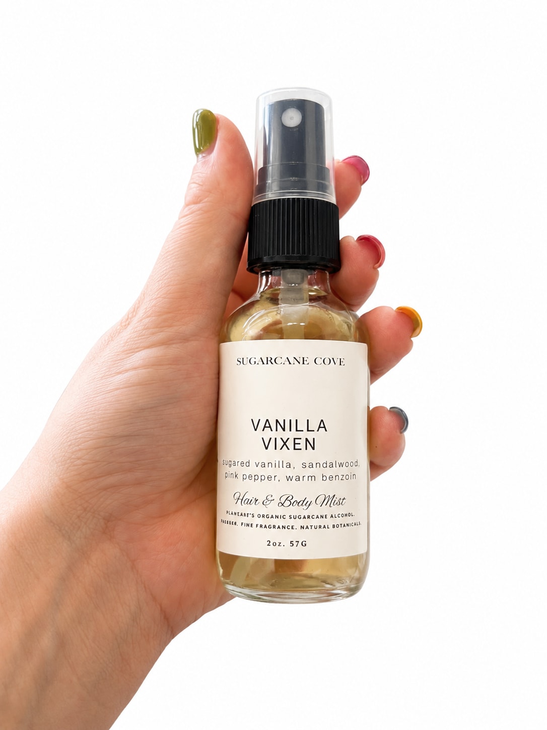 Sugar Cove Body &amp; Hair Mist - A petite, scent-forward pick that reads like a cozy hug in a bottle - perfect as a small gift or add-on for a birthday or "just because" surprise. This hair and body mist is presented in a clear glass bottle with a black spray top and cream label, so the person you're thinking of will get a chic, minimal gift that feels both personal and polished.  The fragrance blends vanilla, sandalwood, pink pepper, and warm benzoin for a soft, warm profile that layers beautifully with floral bouquets without overpowering them. Comes in a travel-friendly spray bottle with a plastic cap and an elegant product label - easy to tuck into a gift box or pair with a small posy. The clean presentation (clear glass, black top, cream label) makes it a natural match for white, black, or neutral-themed arrangements.  Give it as a little extra to make someone feel noticed: an elegant finishing touch for a birthday, thank-you, or thinking-of-you bouquet. The compact size is ready to spritz on the go; no special care needed beyond keeping the label-facing-up and away from direct heat.