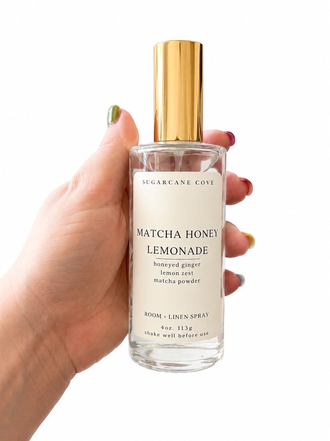Sugarcane Cove Linen Spray - Matcha Honey Lemonade linen spray makes a small space feel like a bright coastal morning - perfect as a housewarming gift or an everyday thank-you for someone who loves fresh, understated home scents. This room and linen spray bottle reads like a little ritual: the clear glass bottle, tall metallic gold cap, and cream label that says "Sugarcane Cove" deliver a clean, spa-like vibe that will make the person you're thinking of feel noticed and pampered.  The scent blends Matcha, Honey, and Lemonade notes for a light, green-floral freshness rather than an overpowering perfume; the bottle's compact, hand-held size pairs beautifully with the other matching goods in the collection - scented candles, small perfume vial, stone soap, and a decorative storage chest - so it's easy to create a thoughtful gift set. The design palette of cream, soft pink accents, green freshness and gold hardware reads luxe but calm, and the glass tray or chest included in some sets makes unwrapping feel special.  Give it to a host, a friend starting a new home, or anyone who loves daily rituals - she'll feel like you brought a little spa day to her living room. Spritz on linens, curtains, or into the air for a subtle lift; the compact bottle is travel-friendly and friendly to everyday use.