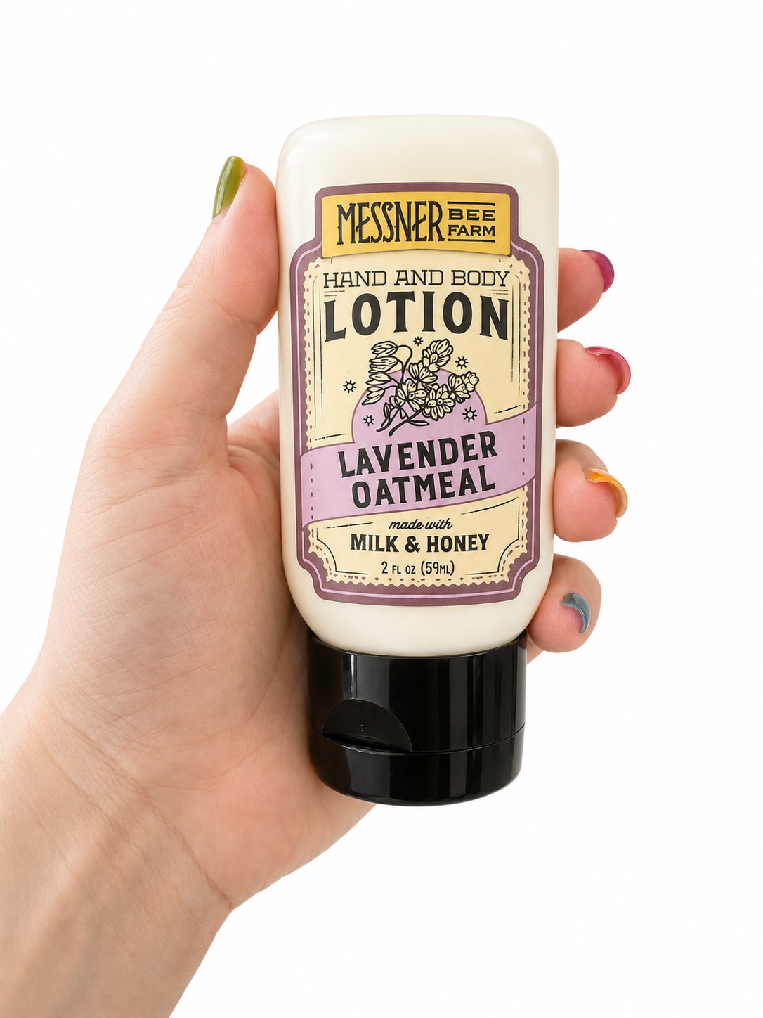 Messener Lotion  - A petite self-care gift centered on - perfect as a small "thinking of you" or hostess present. This hand and body lotion bottle reads like an herbal treat: cream-colored plastic with a black flip-top cap and a vintage, apothecary-style label that says "Lavender Oatmeal” or “ Wildflower Honey” Pair this with a casual gift note for a birthday, thank-you, or just-because moment to let the person you're thinking of relax and feel cared for.  The bottle's lavender-toned graphics and rustic label give it a cozy, handmade vibe that pairs beautifully with white and purple accents if you add ribbon or a matching wrap. Compact and travel-friendly, the lotion is easy to tuck into a gift bag or alongside a small posy. No special care needed - it's ready to gift as-is, and its understated, charming packaging makes the recipient feel pampered without fuss.