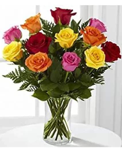 Color Me Pretty - 12 Mixed color roses, assorted greenery, filler flowers, bow and enclosure card. Deluxe = 18 Roses Premium = 24 Roses