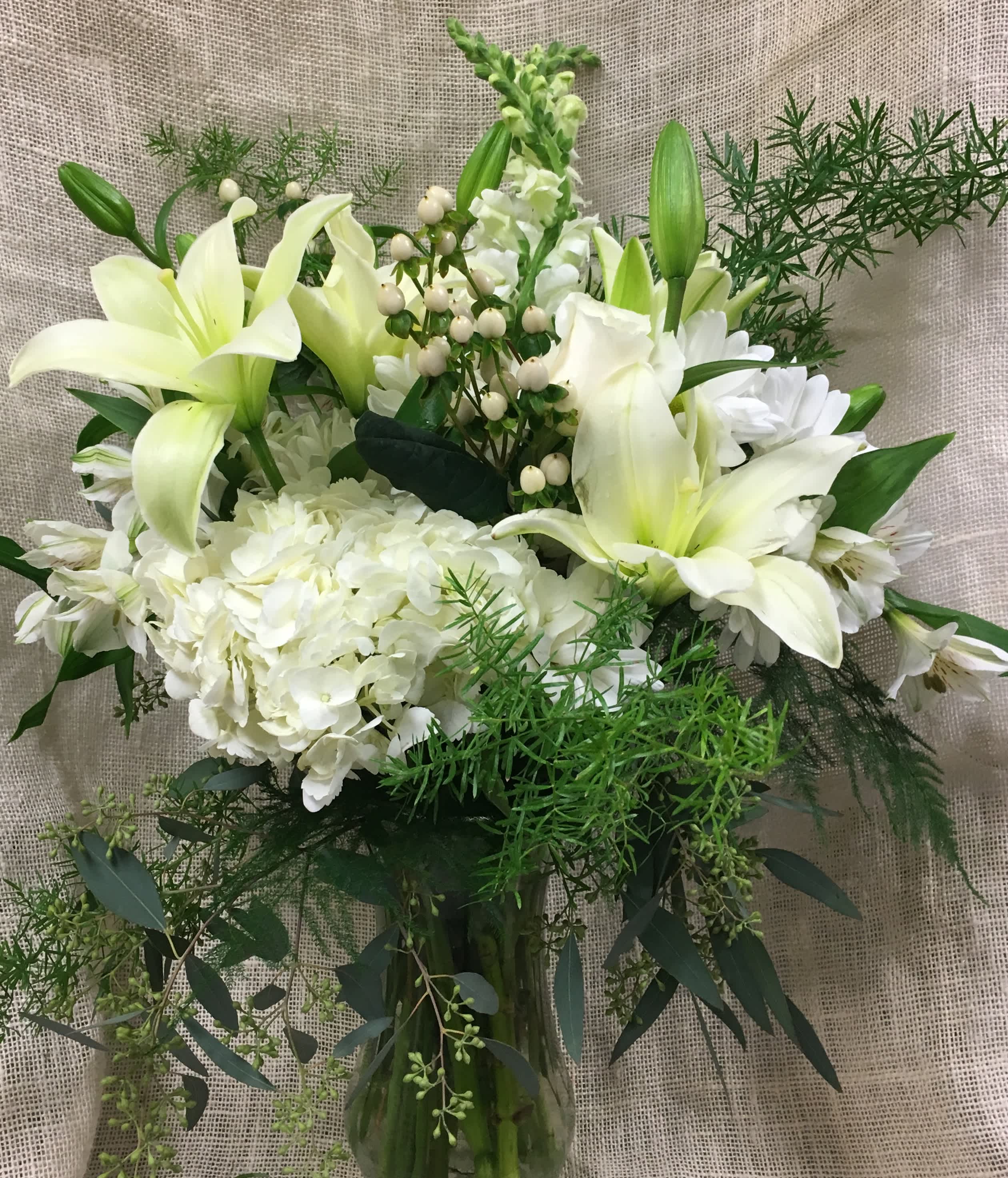 Memories - White flowers with green accents adorn this contemporary arrangement- a perfect look for those who prefer a subtle look of elegance. Classy and modern.