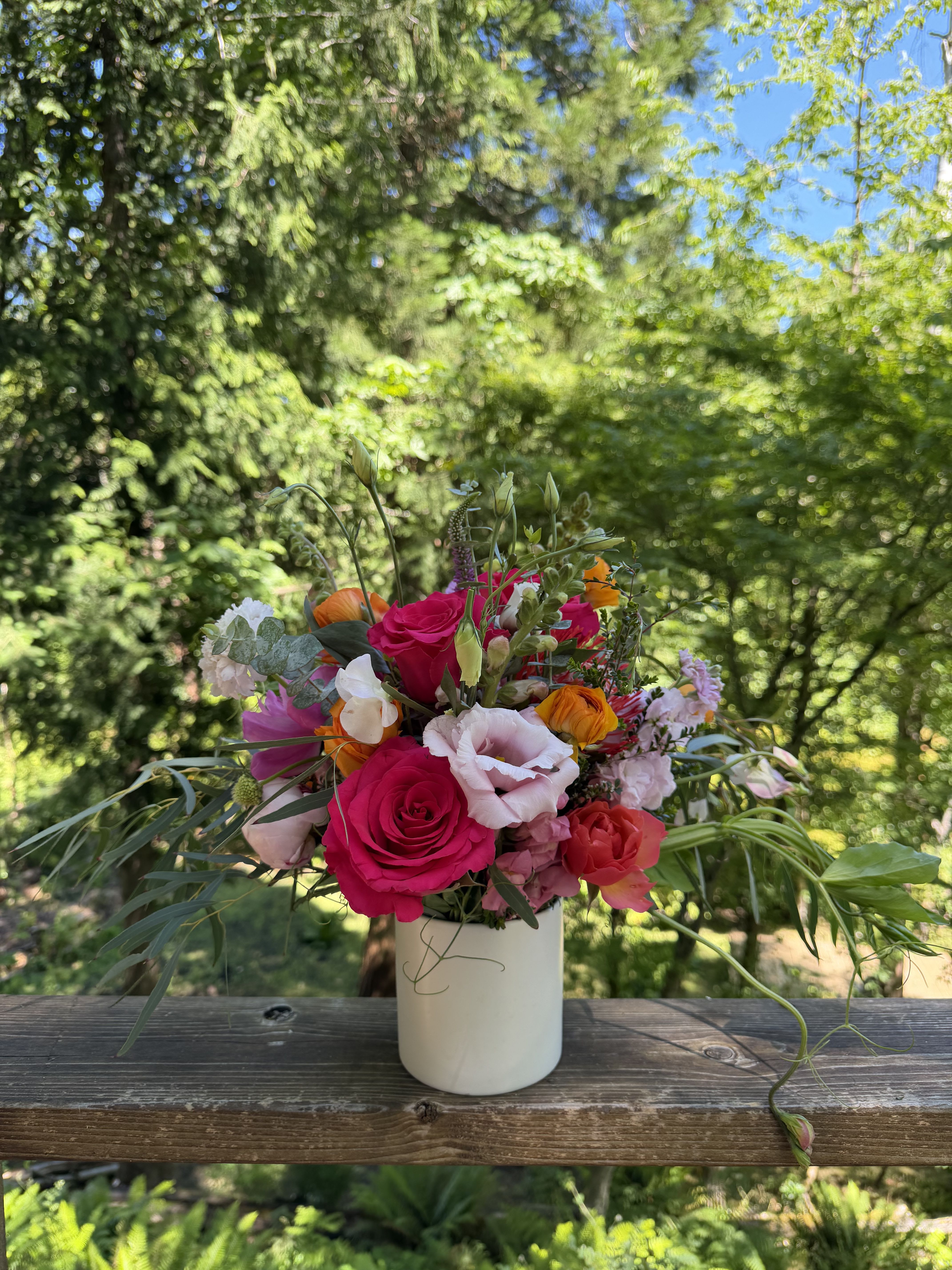 Ilia - Gorgeous seasonal blooms in hot pink, light pink, orange, and purples. Some foliage. 