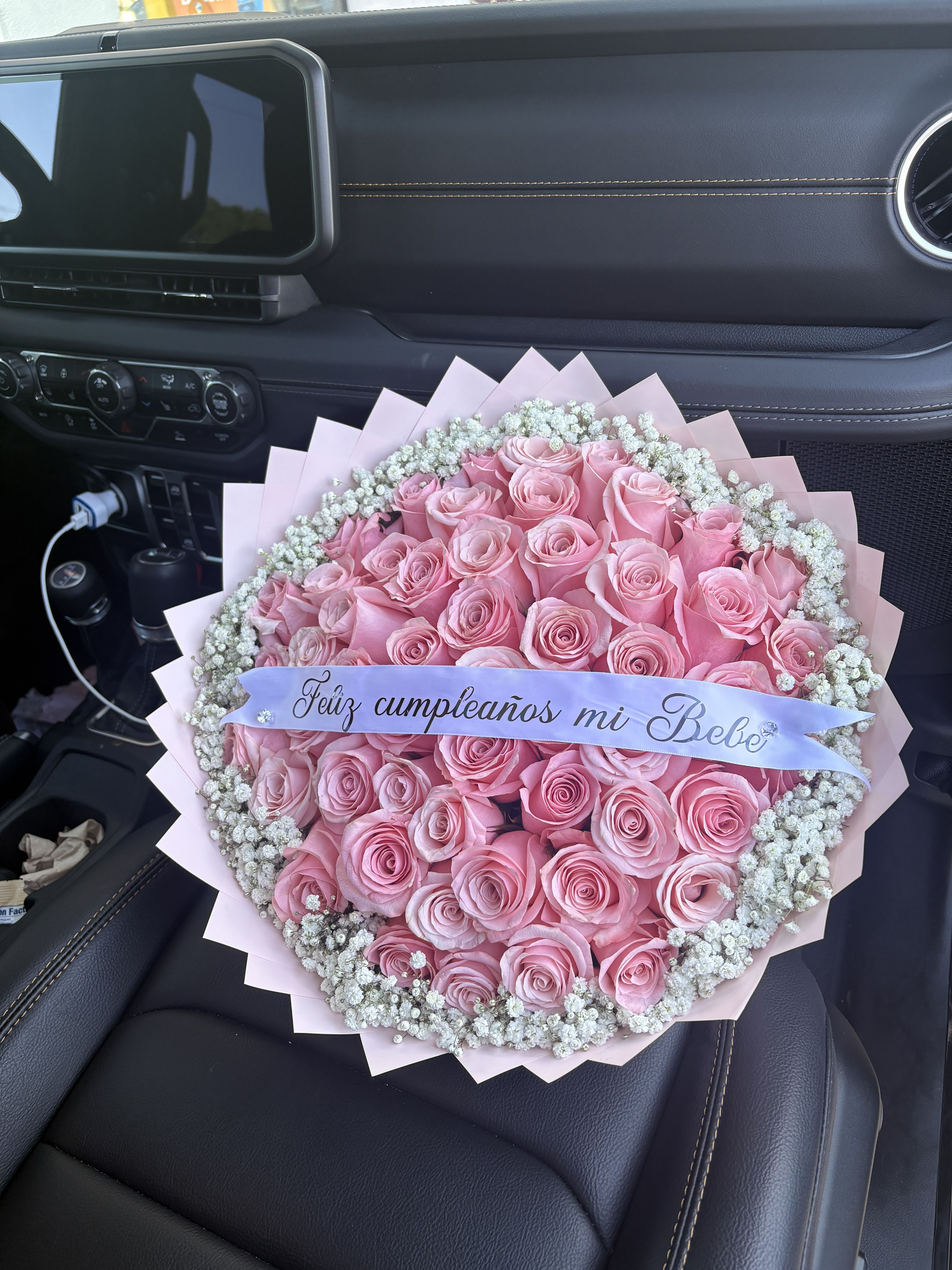 Pink buchon - 50 pink roses with baby’s breath around it.