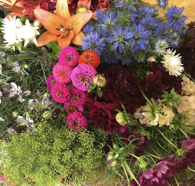 Mixed bouquet with orange lily, blue flowers, and pink blooms