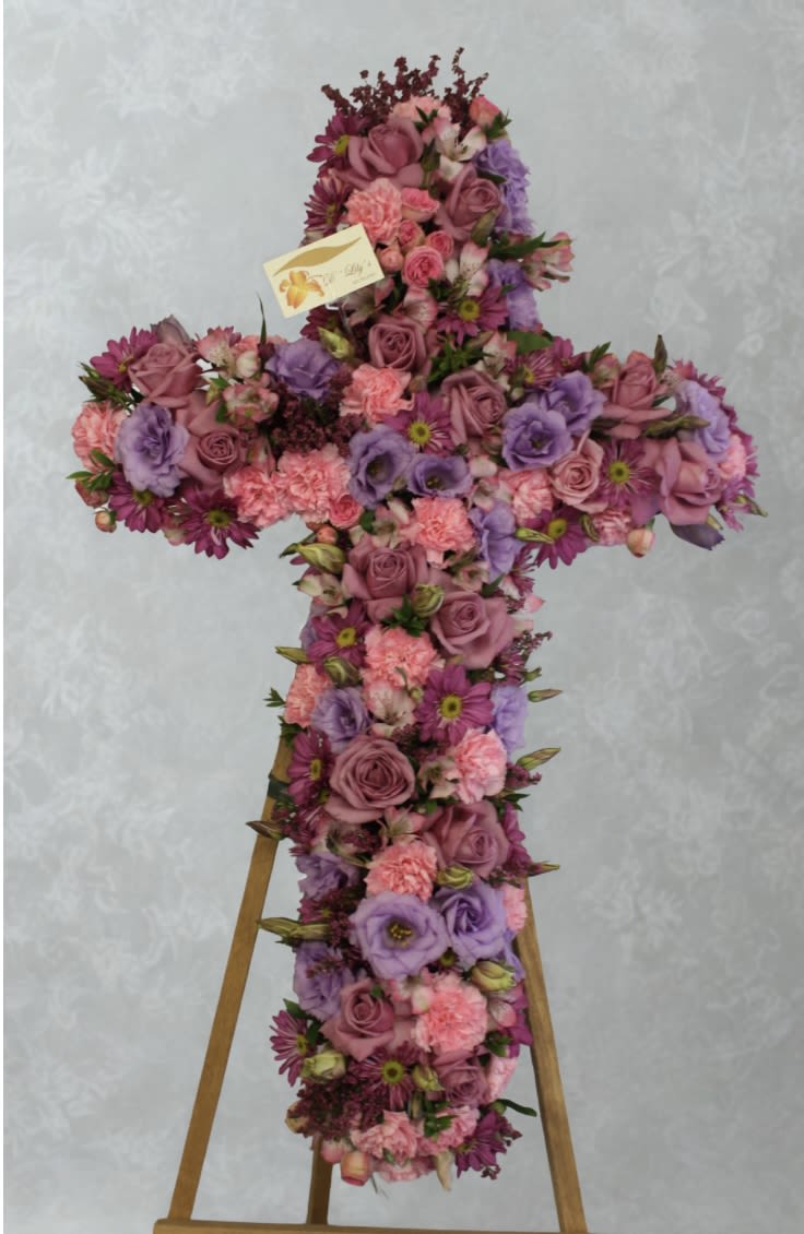 Meadow Fresh - This artfully put together cross in different tones of purples and pinks is the way to say I love you.