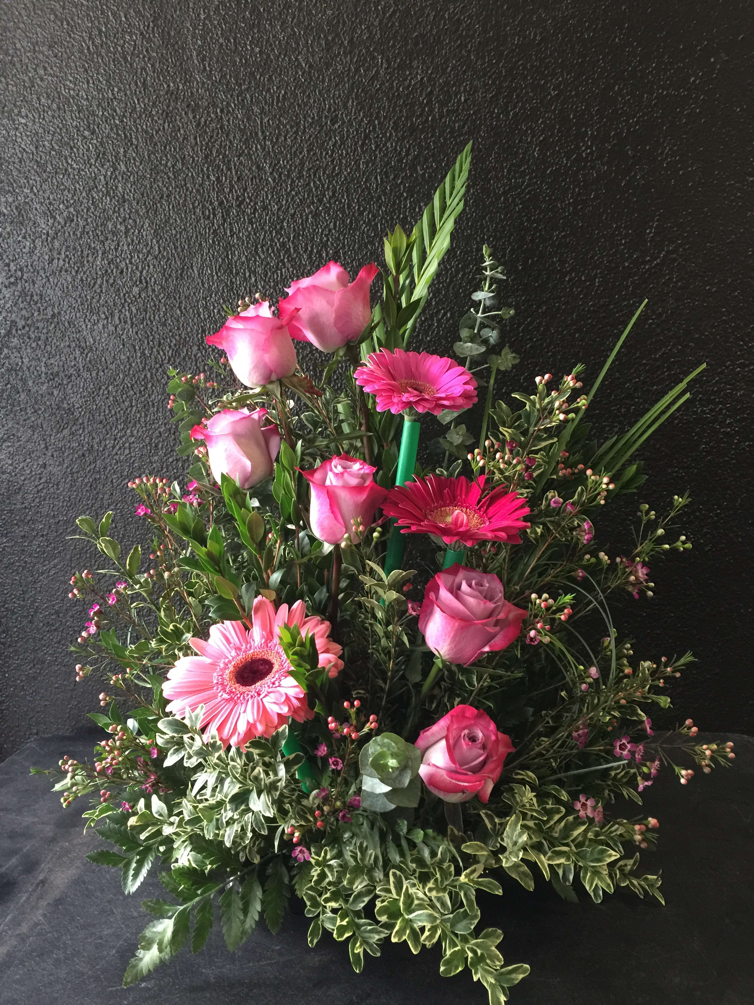Pink roses and gerbera daisies in a lush mixed arrangement