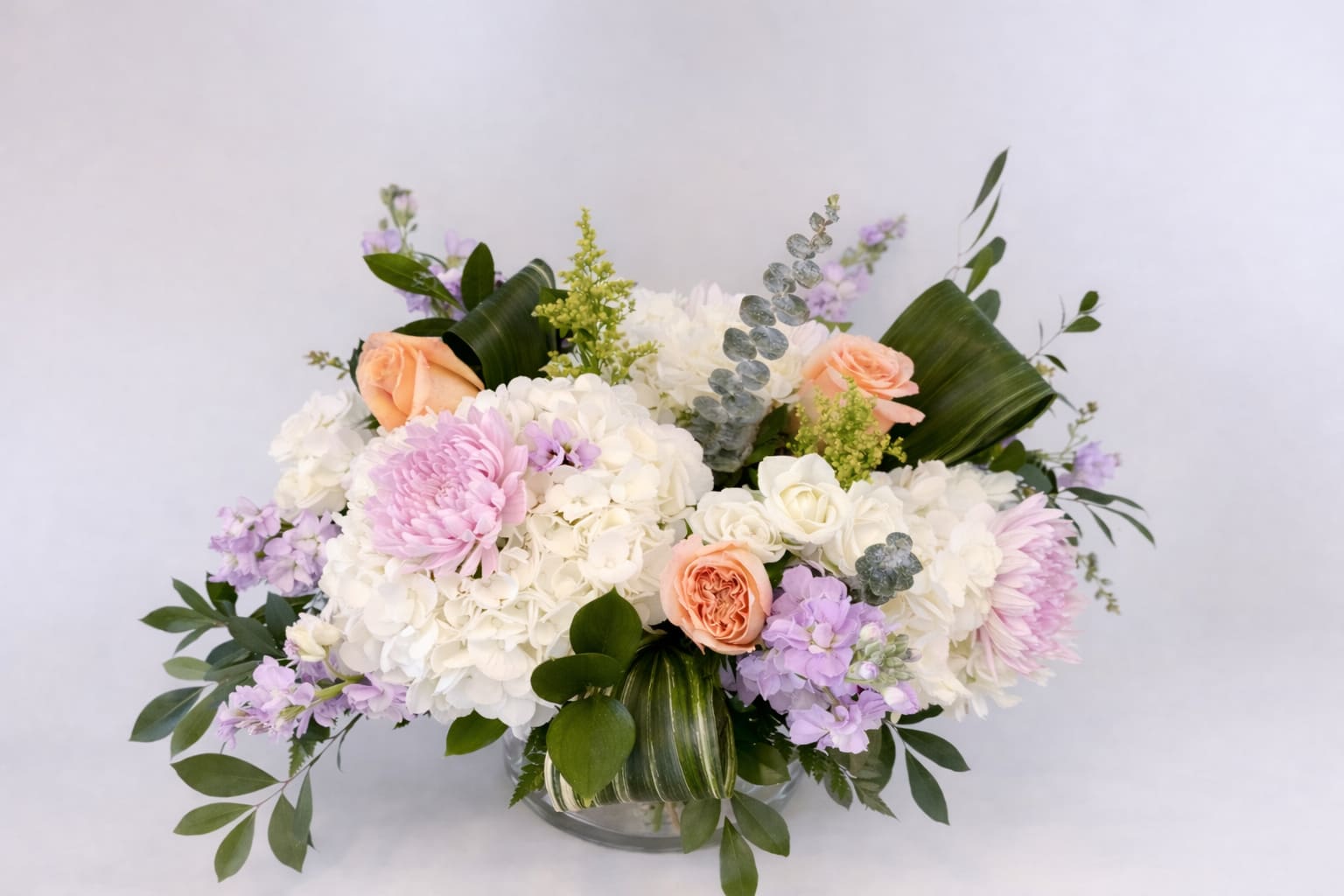 Bouquet of white and pastel flowers in a glass vase