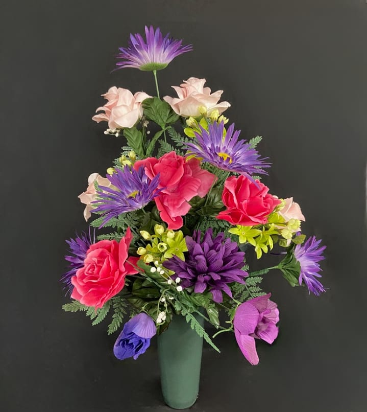 Colorful bouquet of mixed flowers in a green vase