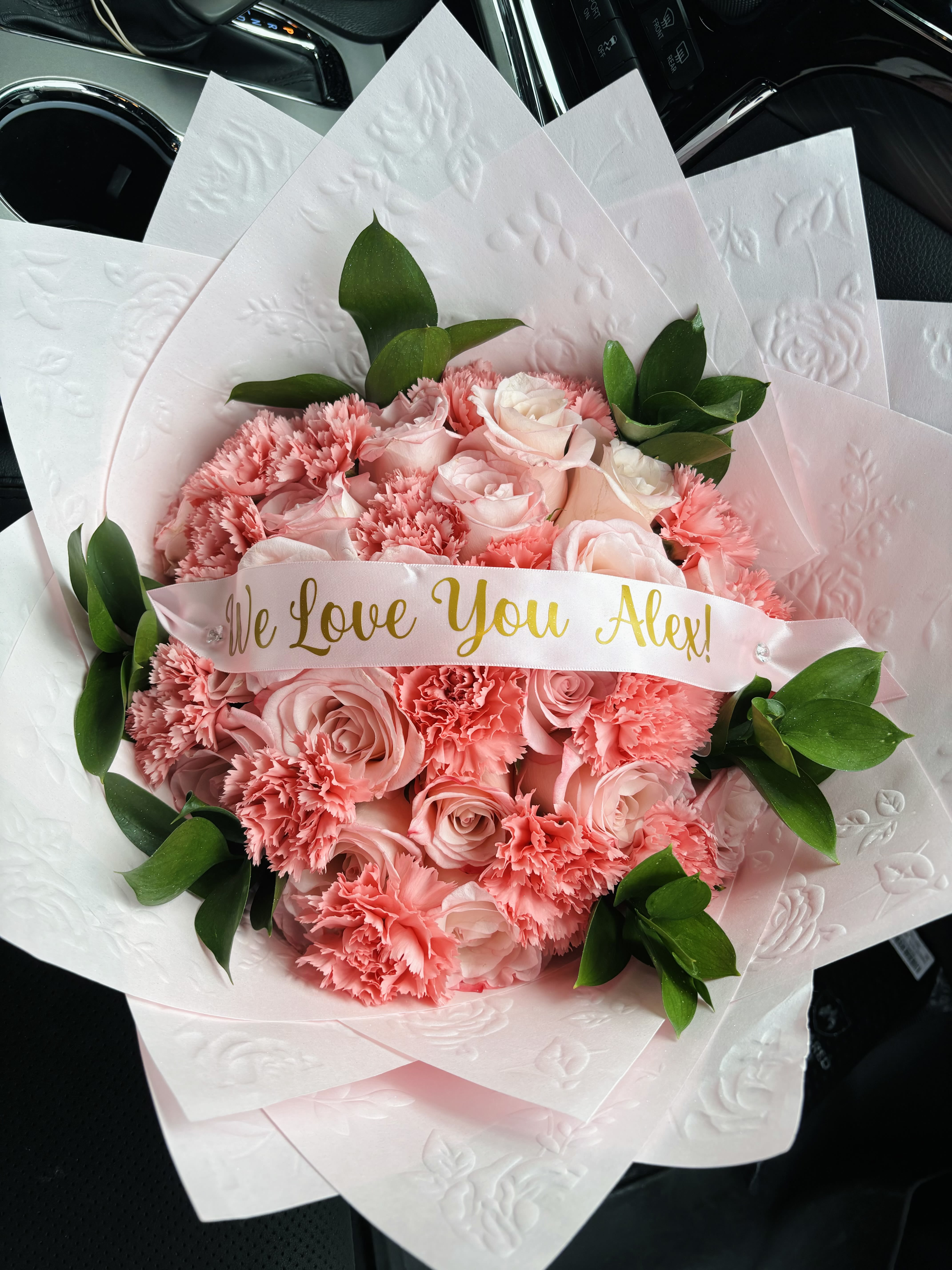 Pink rose and carnation bouquet with a "We Love You Alex!" ribbon