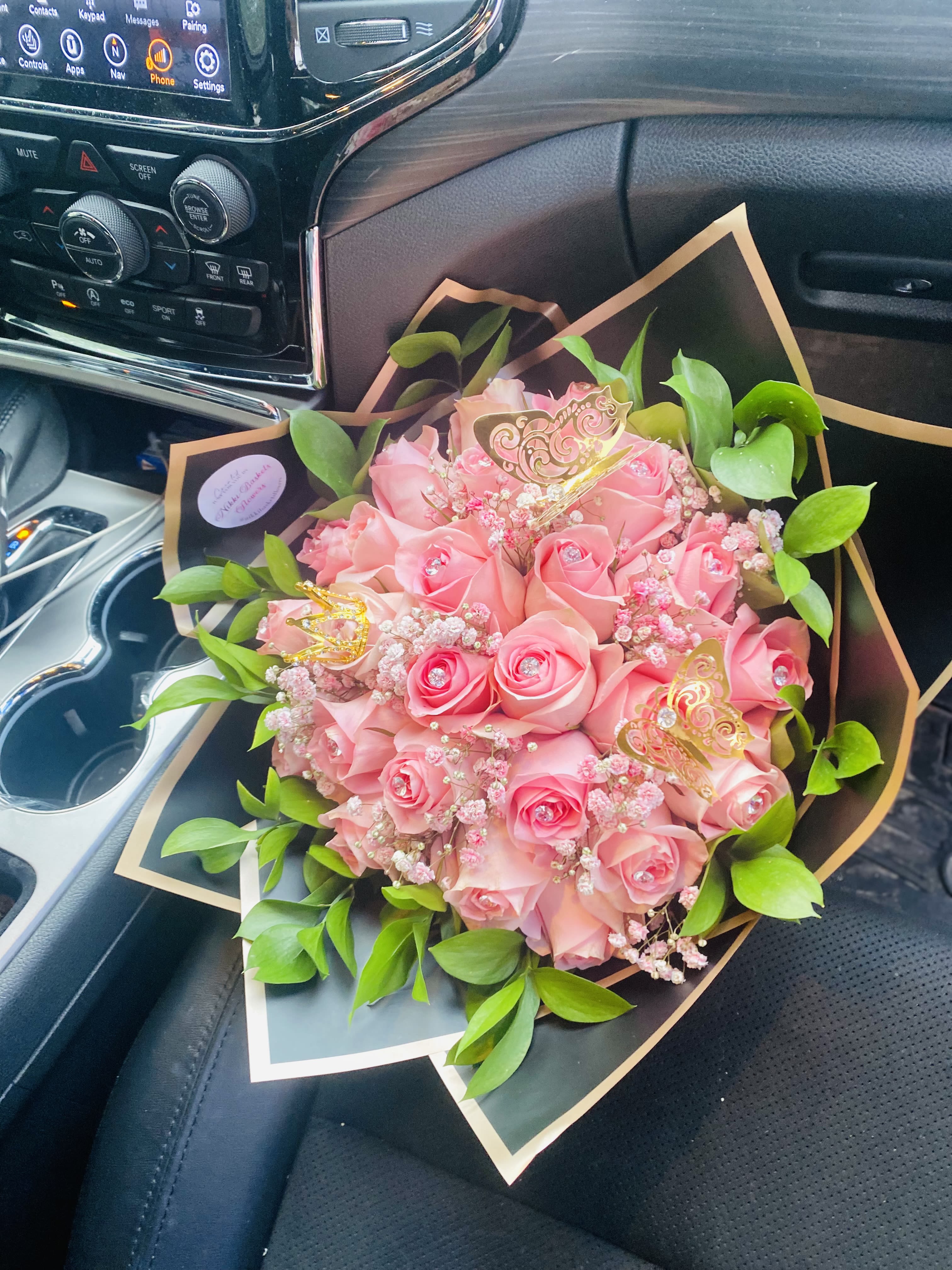 Pink rose bouquet with green leaves and gold butterfly picks