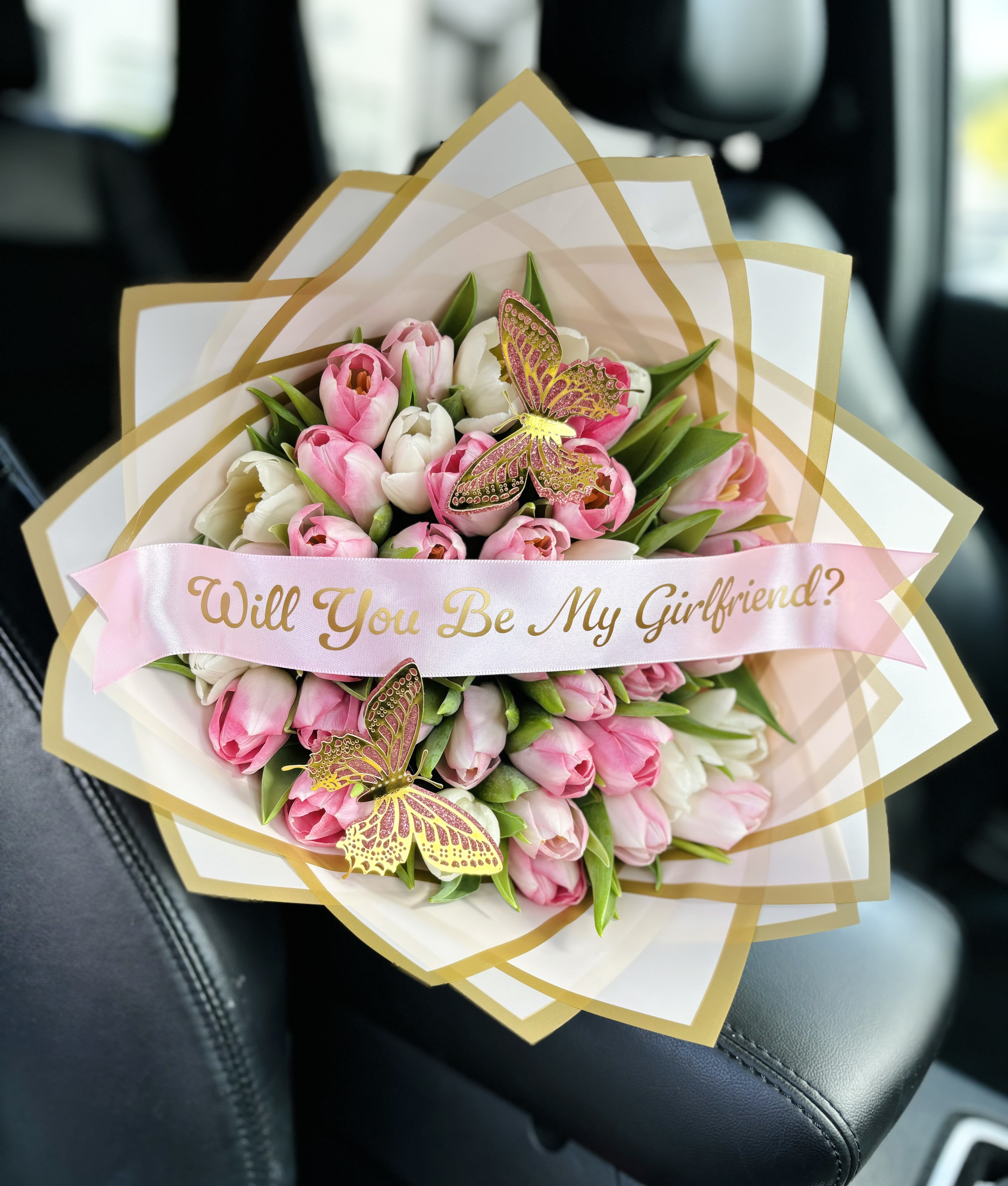 Pink and white tulip bouquet with a "Will You Be My Girlfriend?" ribbon