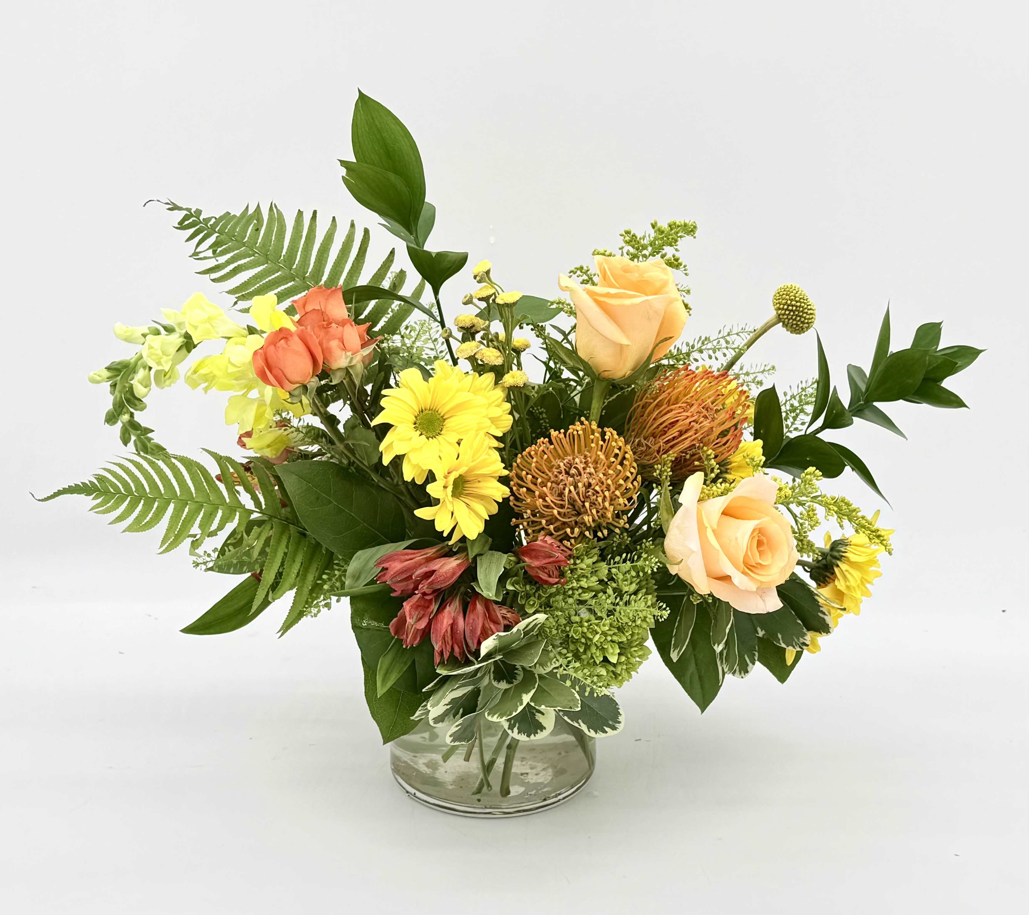 Citrus Zest - Citrus Zest is a bright, cheerful arrangement inspired by the fresh colors of citrus fruits. Featuring sunny yellow blooms, pops of vibrant orange texture, this design brings a refreshing burst of color to any occasion!