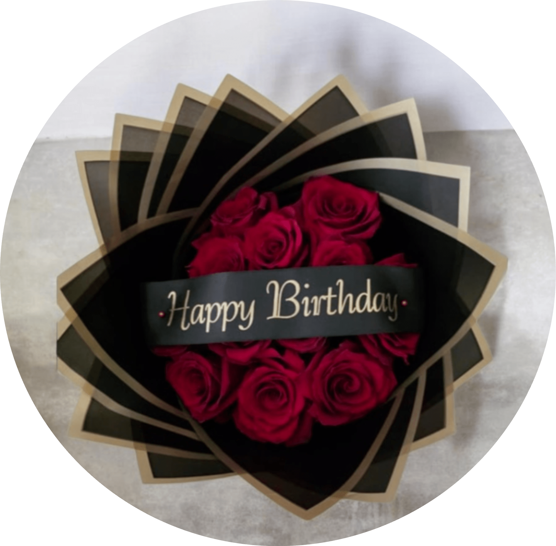 HAPPY BIRTHDAY.  - A dramatic cluster of deep red roses wrapped in sleek black packaging makes this birthday bouquet feel like a luxurious gift - perfect as a birthday bouquet or a romantic anniversary surprise. The "Happy Birthday" band and coordinated ribbon read as celebratory at a glance, so the person you're thinking of will feel seen and special the moment they open it.  Tightly arranged red roses sit inside layered black wrapping or a black-and-gold decorative gift box with tan or gold edging, creating striking contrast that highlights the rich, velvety petals. Presentation includes a printed birthday band, decorative paper wrap and ribbon, and a keepsake black gift box so the arrangement arrives ready to give.  Ideal for a romantic birthday, milestone celebration, or anyone who prefers bold, elegant style; the compact cluster makes a strong visual statement while staying easy to display. Order with same-day delivery where available to ensure the freshest presentation - the packaging helps protect the blooms and keeps the bouquet ready to admire right away.