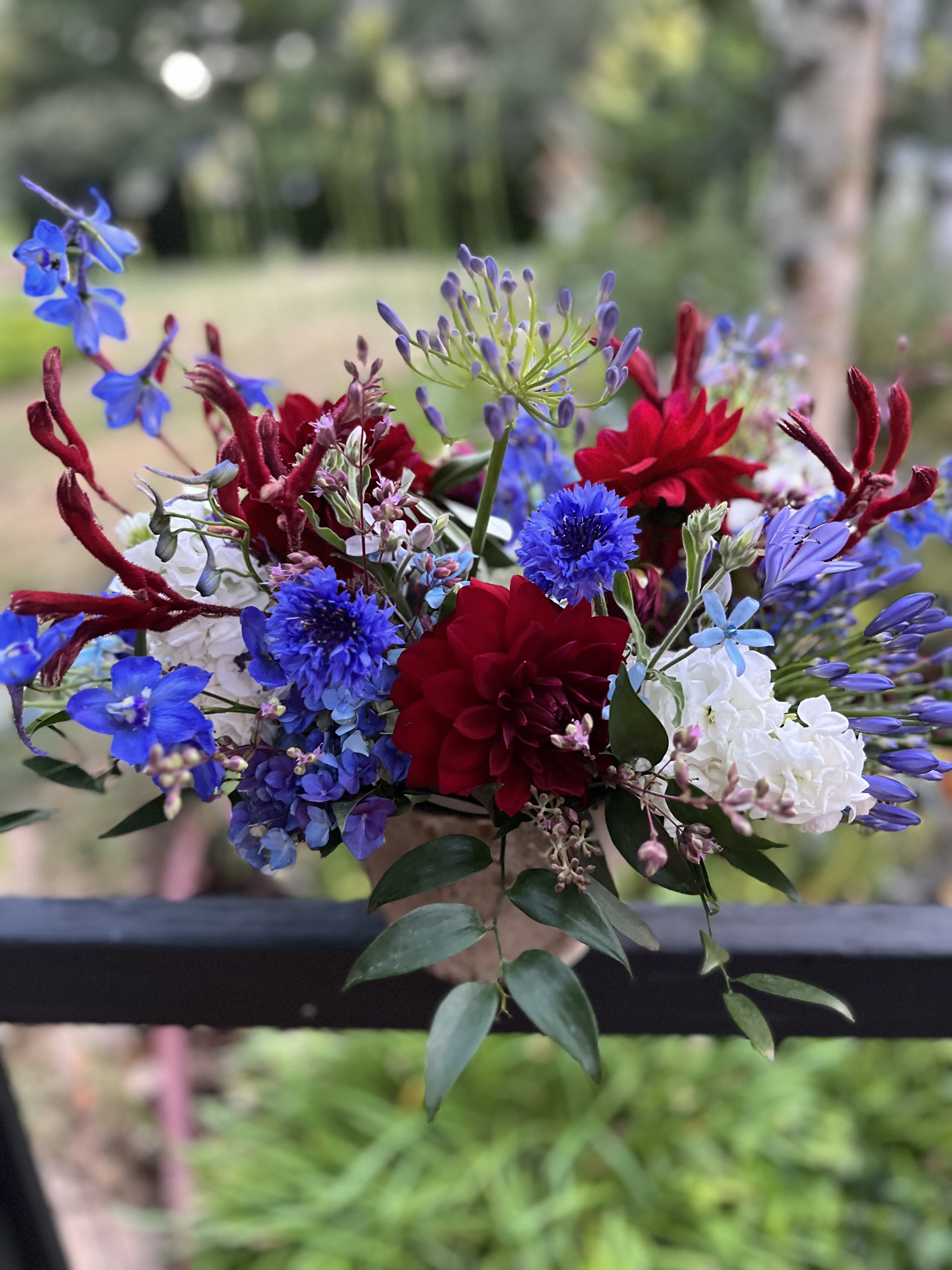 Fireworks at the Farm  - Celebrate Independence Day with these red, white, and blue blooms. Featuring our Dalia’s from the farm, in a spread of blue flowers; fire up the grill! 