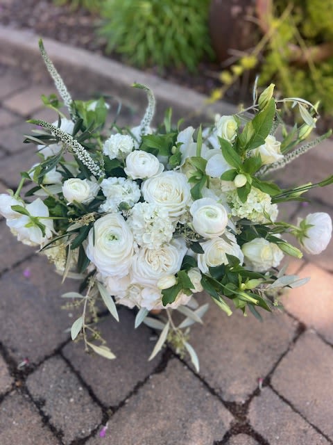 White bouquet of roses and ranunculus with greenery
