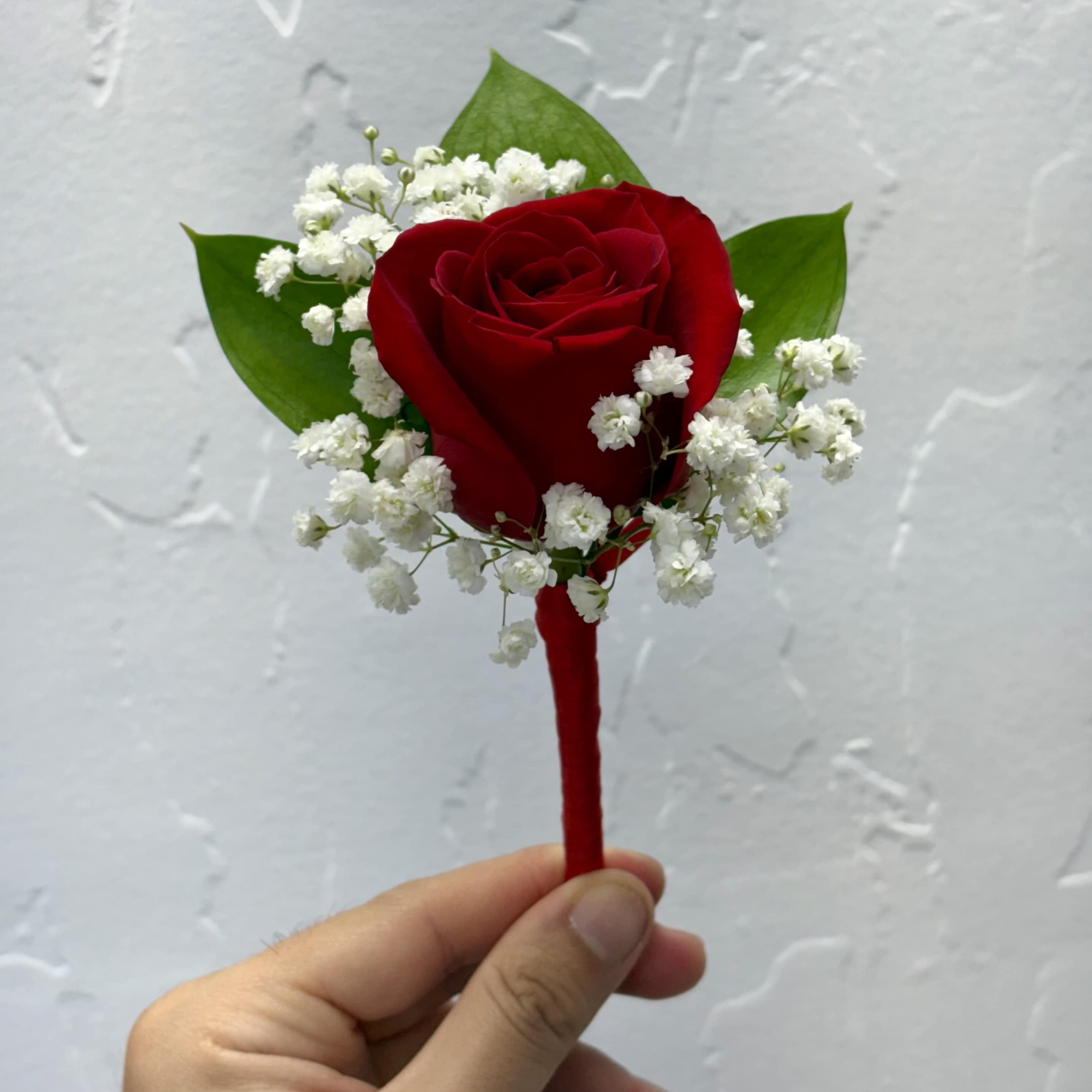 Classic and Modern Boutonniere - Classic and modern boutonnieres featuring hand-selected roses and refined greenery. A distinguished finishing touch for grooms, groomsmen, or prom nights. Customize the bloom and ribbon color to suit your style.  To personalize your boutonniere, simply include your preferred flower type, color, and ribbon choice in the "Special Notes" section at checkout. We’ll create a custom piece made just for you.