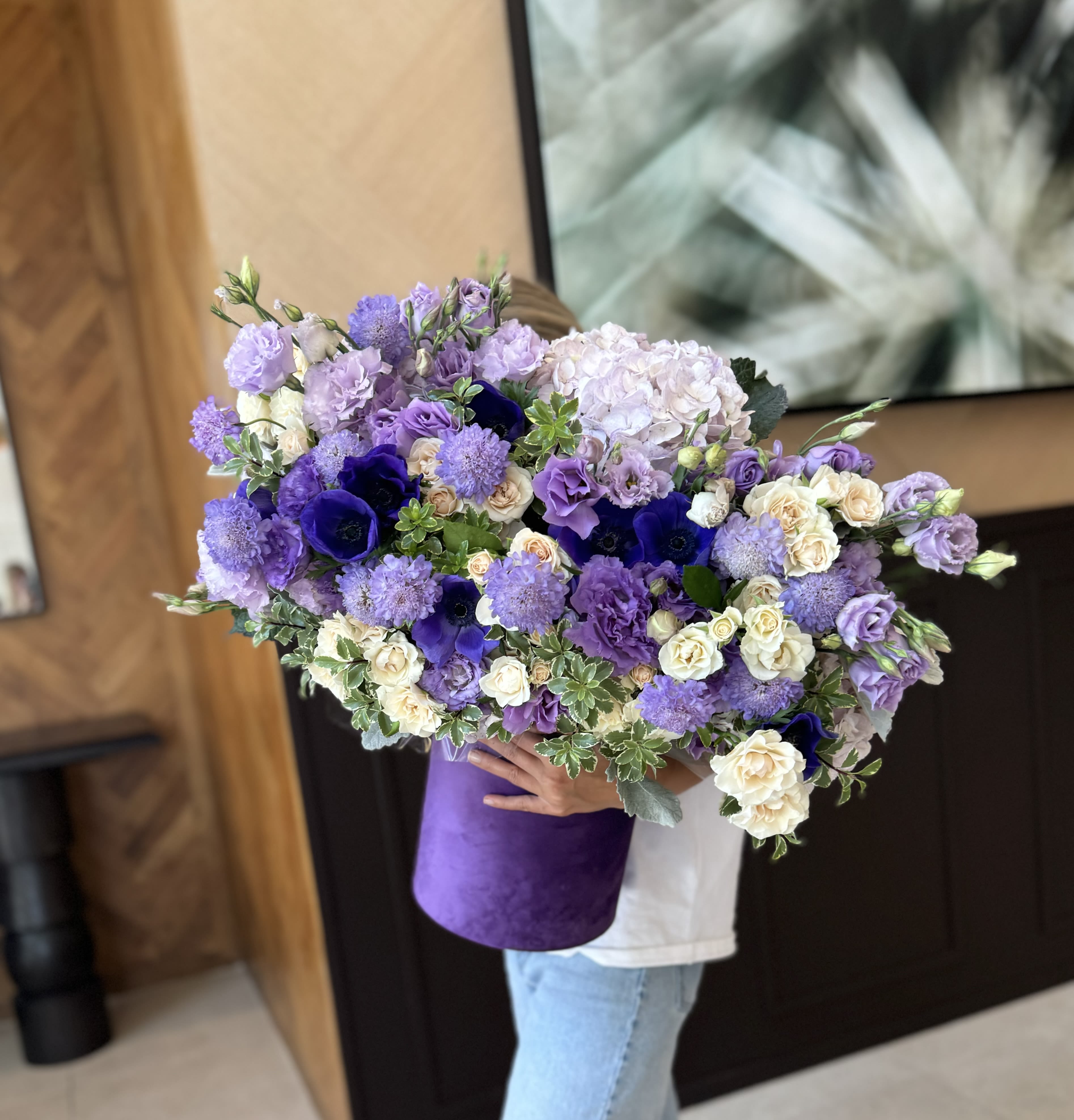 Large bouquet of purple and white flowers in a purple wrap