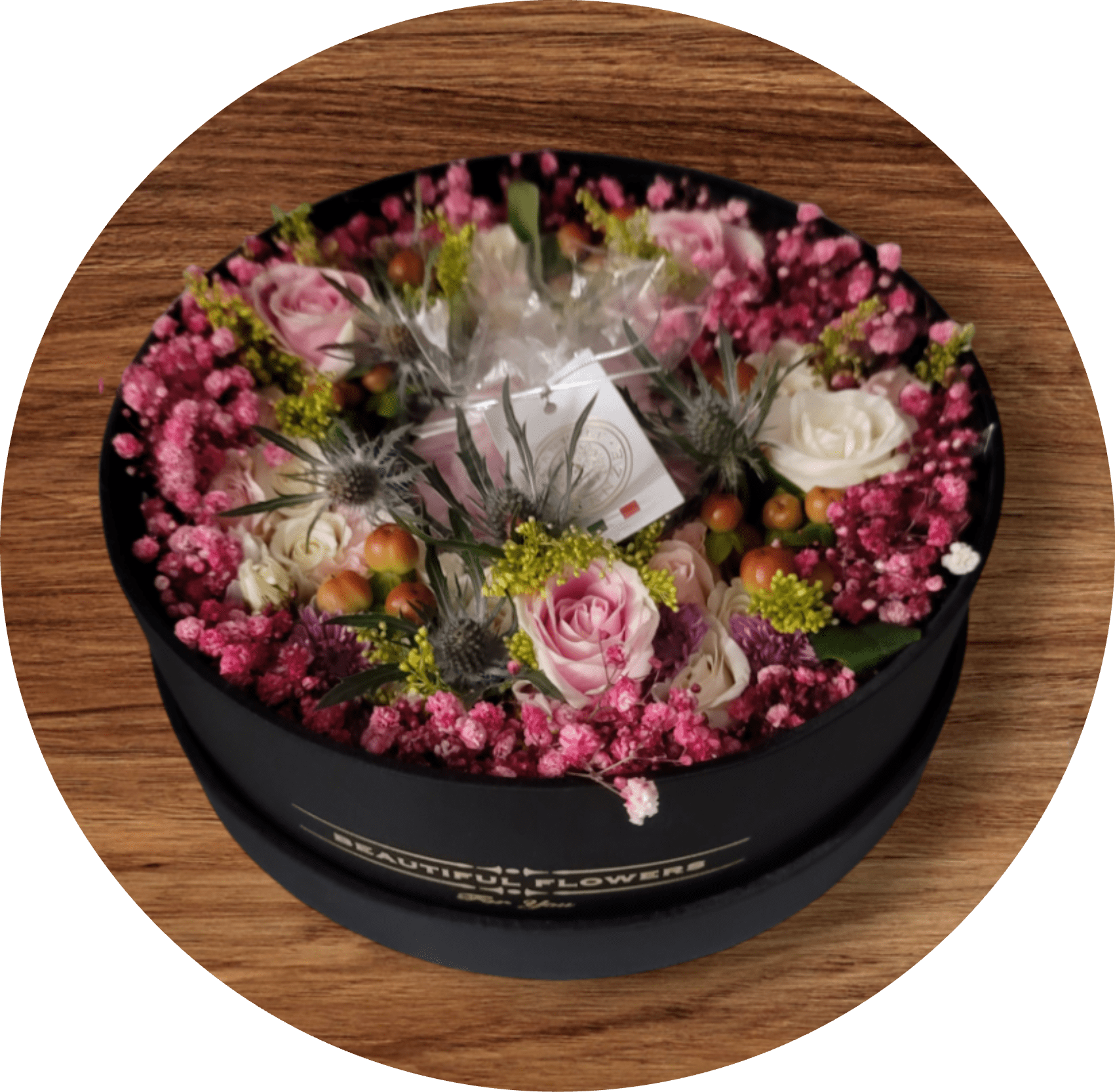 Round box of pink and white roses with small filler flowers