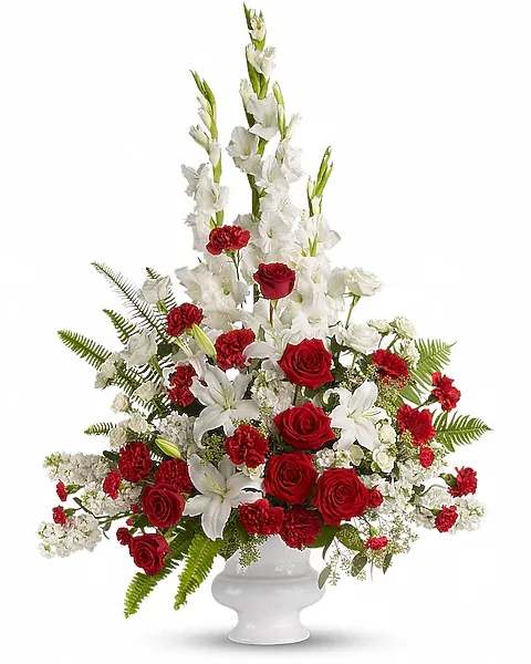 Memories to Treasure - For the sweet spirits who touch our lives, a classic pairing of red and white that is both vibrant and respectful. Beautifully contained in a white urn. A mix of fresh flowers such as red and white roses, oriental lilies, graceful gladioli, carnations and fragrant eucalyptus. Beautifully presented in a white urn.