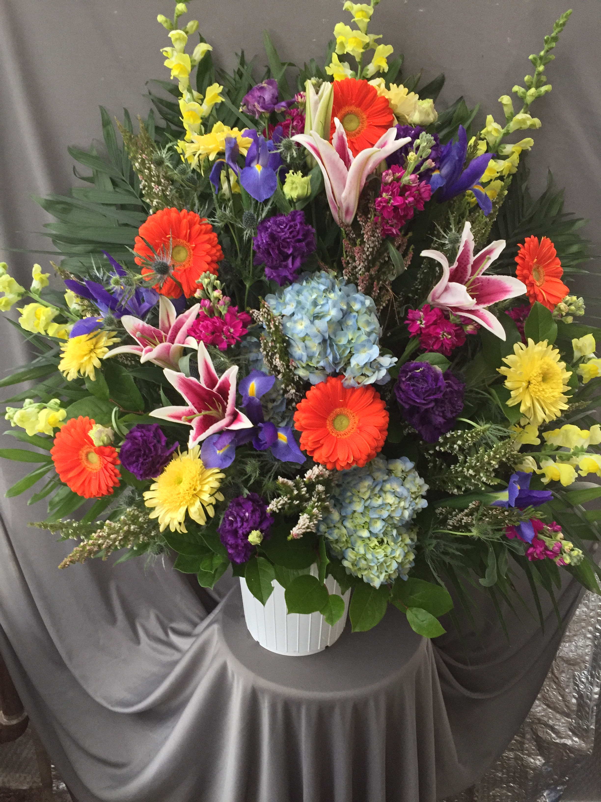 Colorful mixed flower arrangement in a white vase