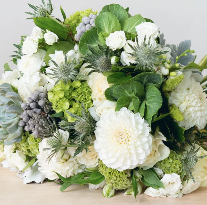 Designer's Choice - Sympathy Mix - Our designers will hand-select the freshest seasonal flowers available to create a beautiful, custom vase arrangement. Flower varieties may vary throughout the year based on seasonal and market availability, ensuring each design is unique and crafted with the highest-quality blooms.