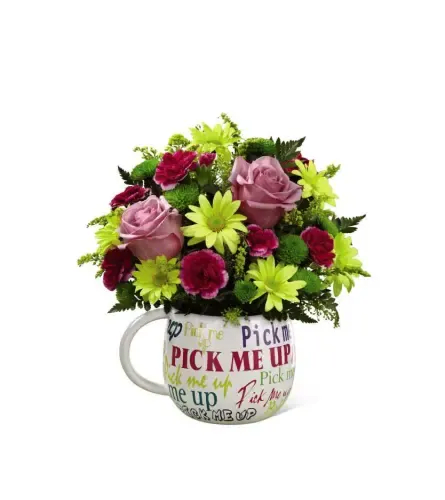 pick me up bouquet - Soft pink roses paired with bright lime-green daisies and deep magenta accents create an energetic, uplifting bouquet perfect as a get well, thinking-of-you, or just-because flower arrangement. This pick me up bouquet arrives tucked into a white ceramic mug printed with repeated "Pick Me Up" text, making it an encouraging, casual gift that feels personal and cheerful for the person you're thinking of.  The compact, rounded design combines roses, daisies, carnations, and additional seasonal blooms in a lively mix of pink, green, yellow, and white. Textures range from the velvety rose petals to the crisp daisy centers and ruffled carnations, giving the display visual contrast that pops in small spaces-designed to brighten a bedside table, desk, or kitchen counter.  Give this to someone who needs a smile: it reads as thoughtful without being formal, the kind of arrangement that says "I'm thinking of you" in a light, optimistic way. The ceramic mug makes it easy to reuse, and the compact size is ideal for same-day flower delivery or a last-minute pick-me-up.