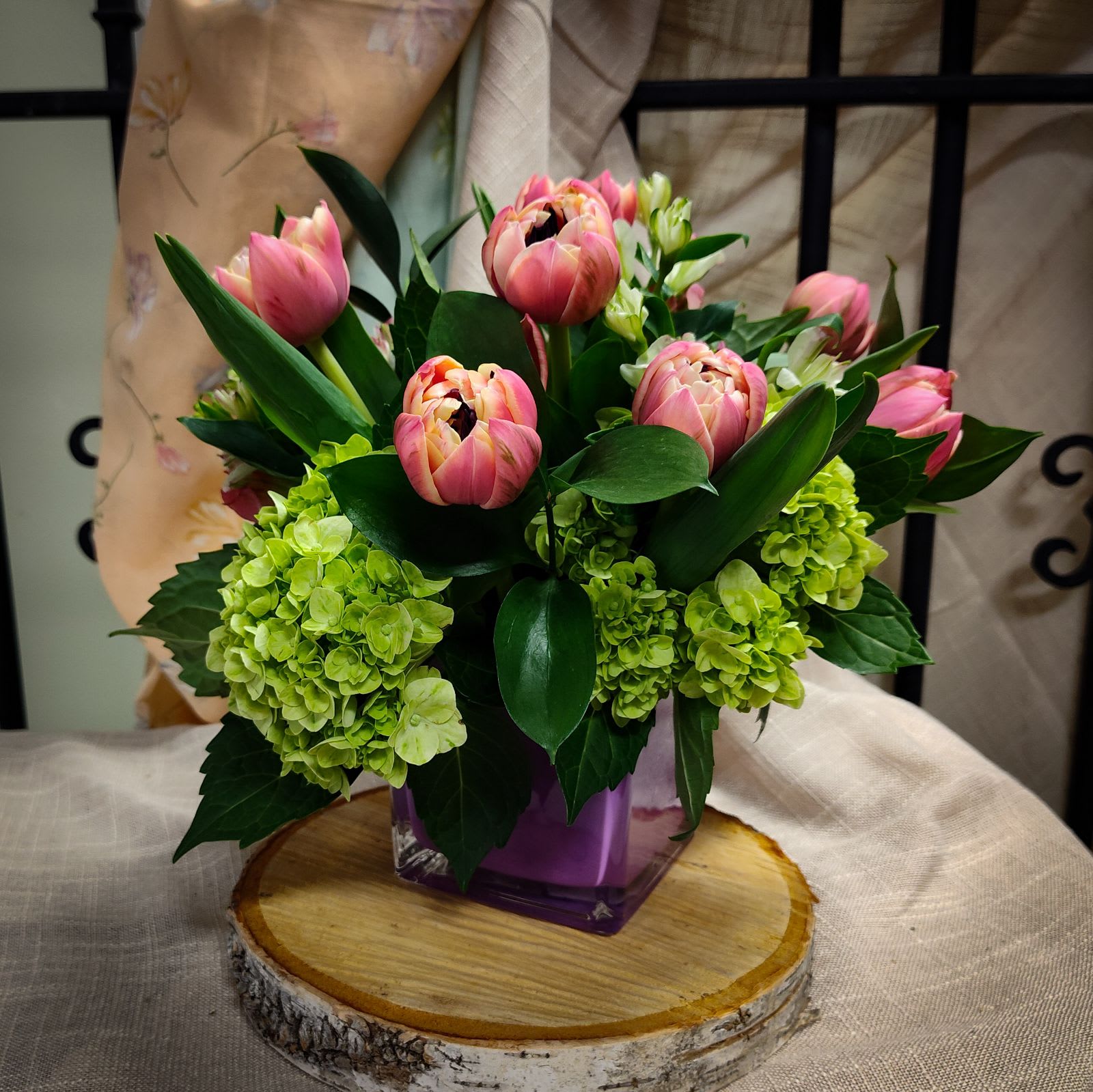 Spring Tulip Vase - Please Note: Each design is custom made and filled to value. We only use fresh product to ensure top quality so new orders are subject to substitutions.  Vase and vase color may vary.